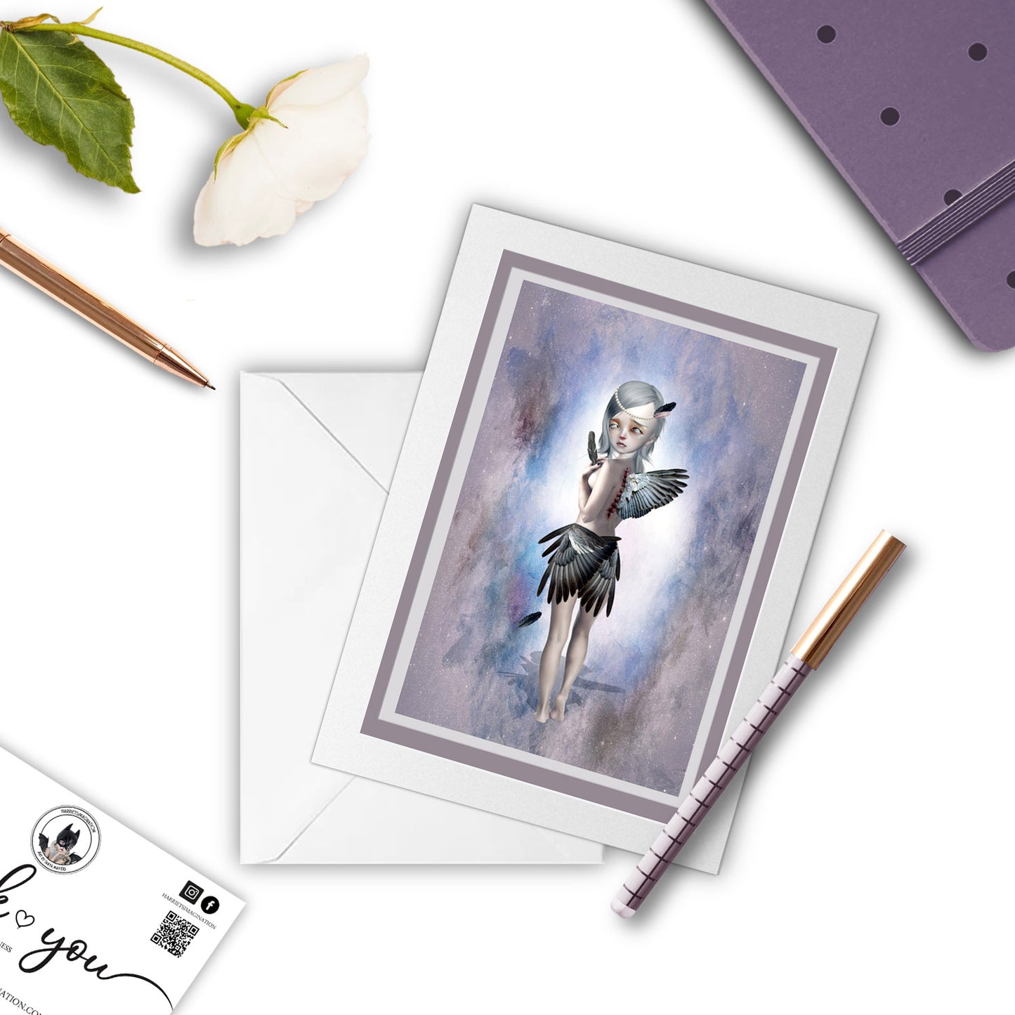 Broken Angel greeting card beside a notebook and pen – perfect for gifting or writing a dark, poetic note.