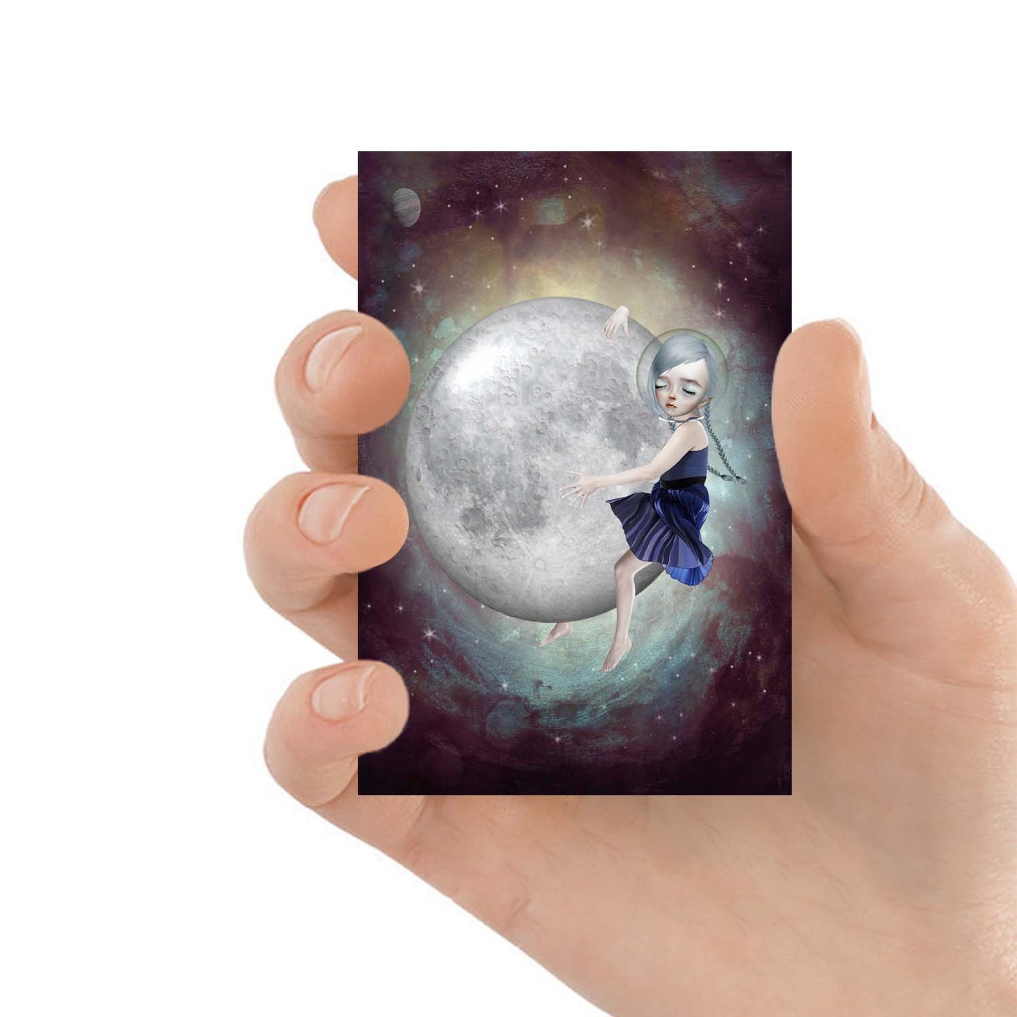 Hand holding ACEO display features a girl embracing the moon in outer space.