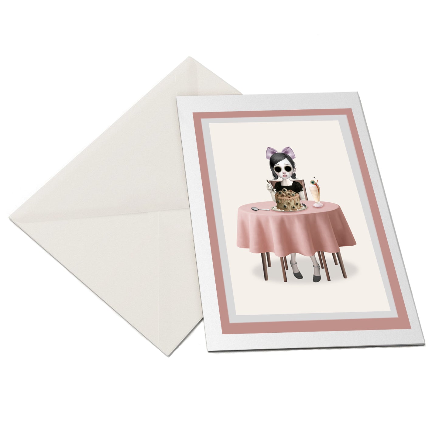 Flatlay of surreal greeting card with envelope – eyeball cake artwork