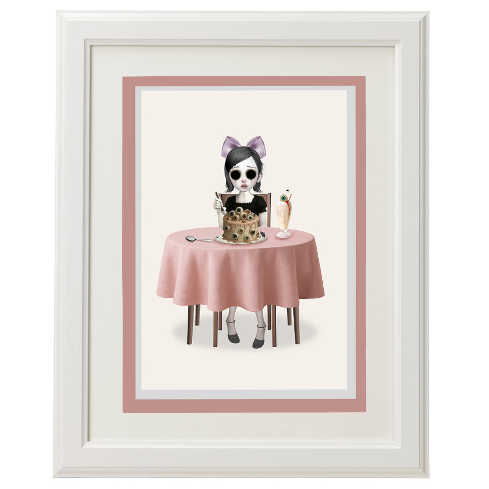 Surreal greeting card framed on wall – eyeless girl and eyeball cake art