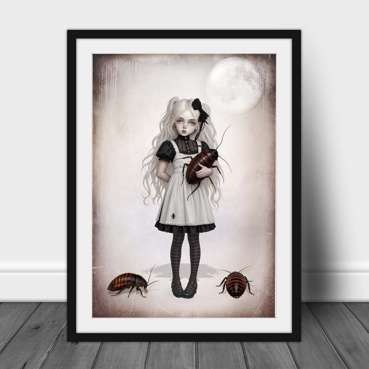 A3 Framed art print of a whimsical gothic girl with pigtails holding a giant cockroach against a pale moon backdrop
