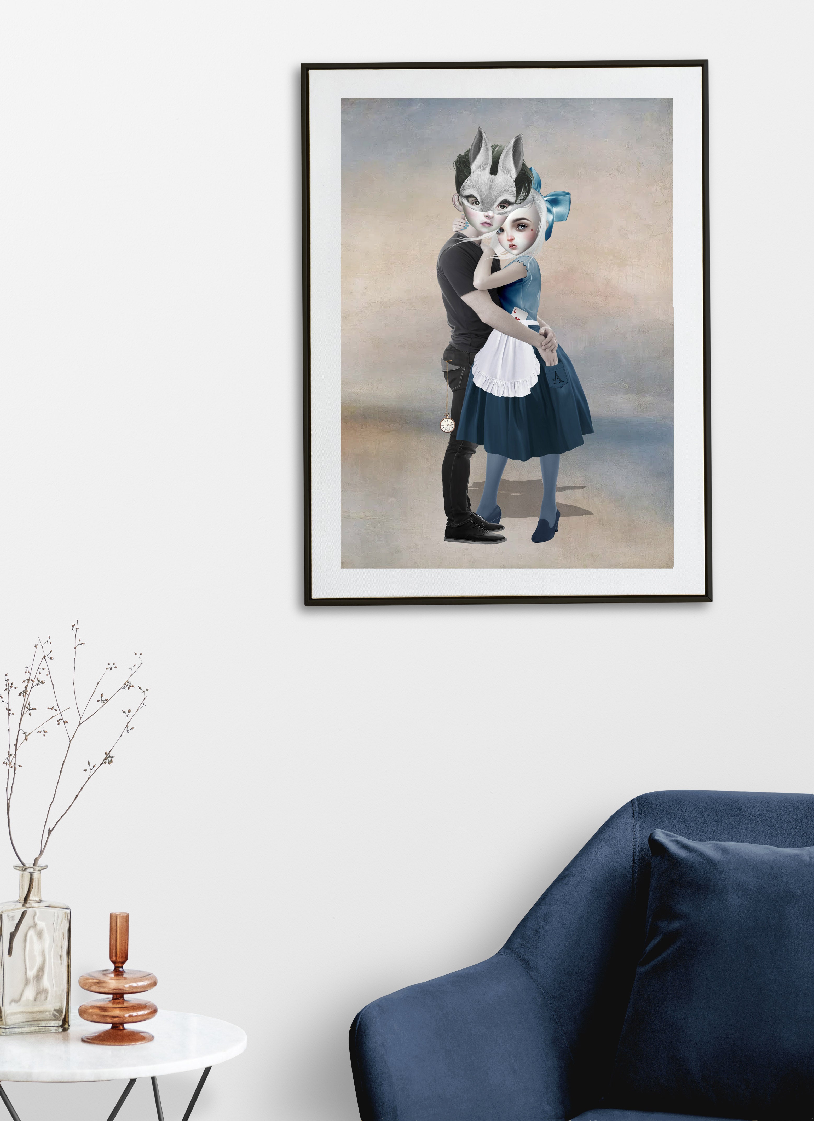 Framed artwork of a fairytale couple embracing on a white wall with a blue sofa and small table in the foreground.