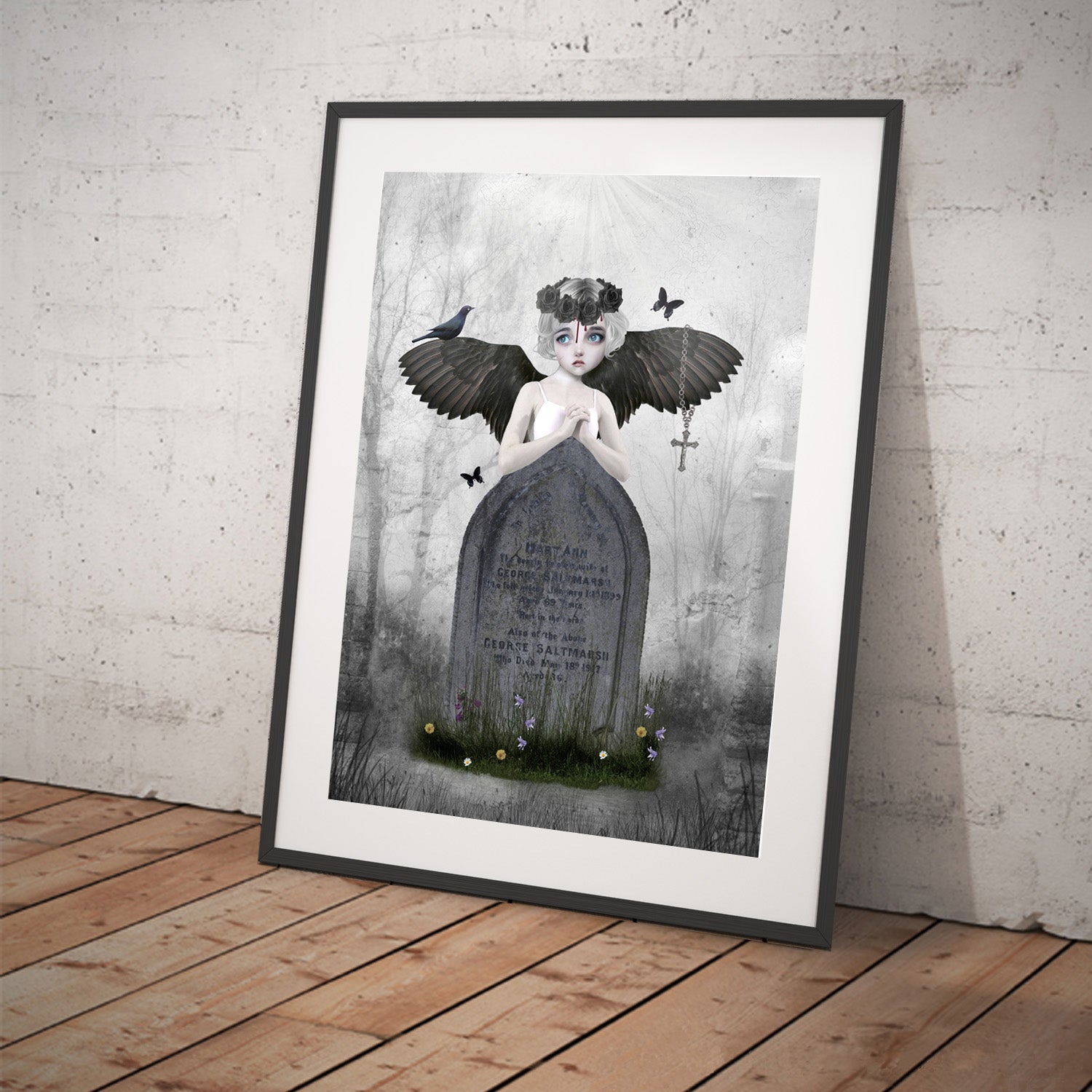 Framed angel art print, image is a fallen angel looking lost among the headstones in a cemetery.