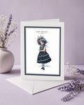 Aquarius zodiac birthday card featuring an illustration of a dark-haired maiden with wild wave hair topped with a miniature ship and an octopus tentacle around her shoulder.