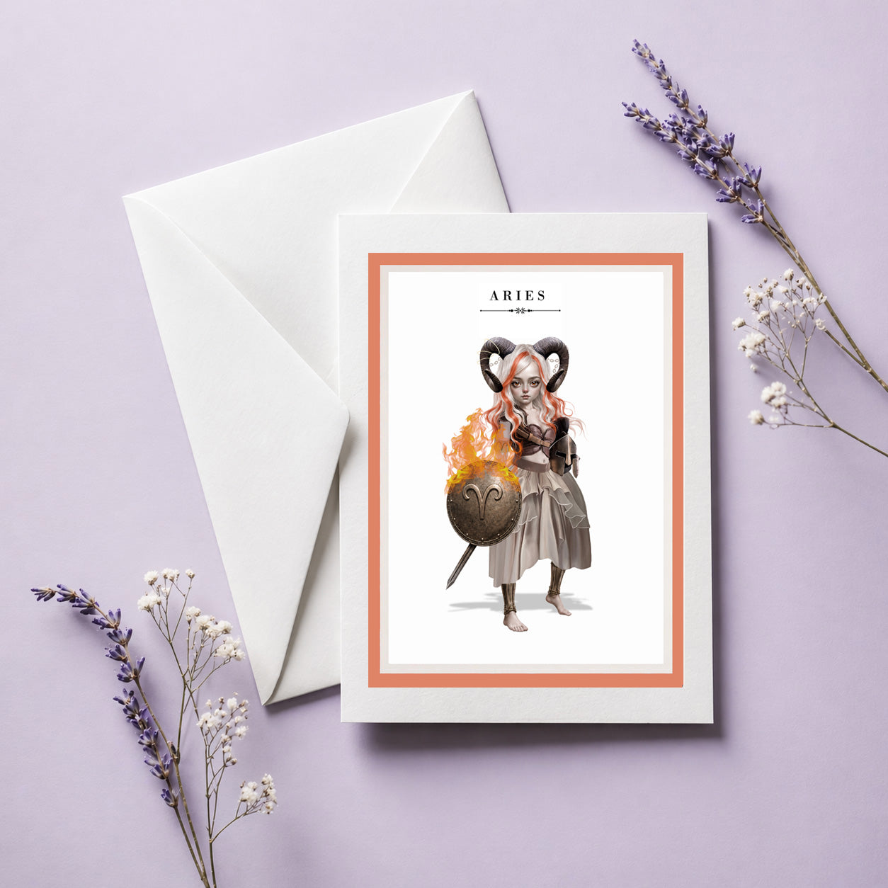 Aries zodiac birthday card with envelope featuring an illustration of a white and orange-haired warrior maiden with ram horns holding a flaming bronze shield.
