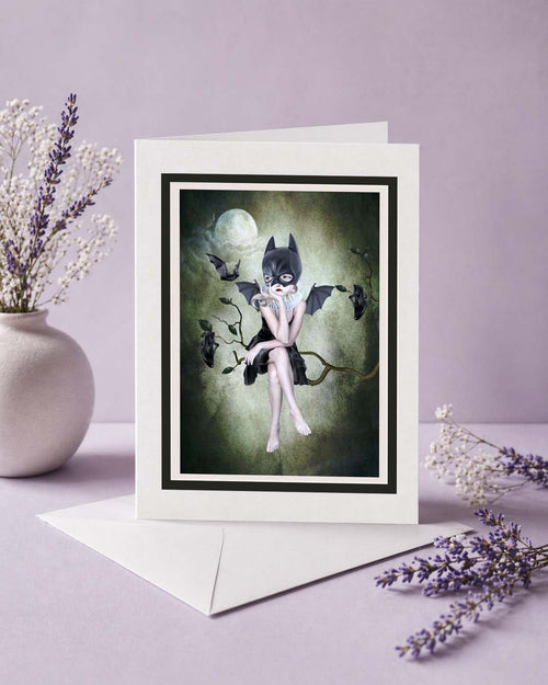 Greeting card with a bat-themed illustration on a light purple background with flowers.