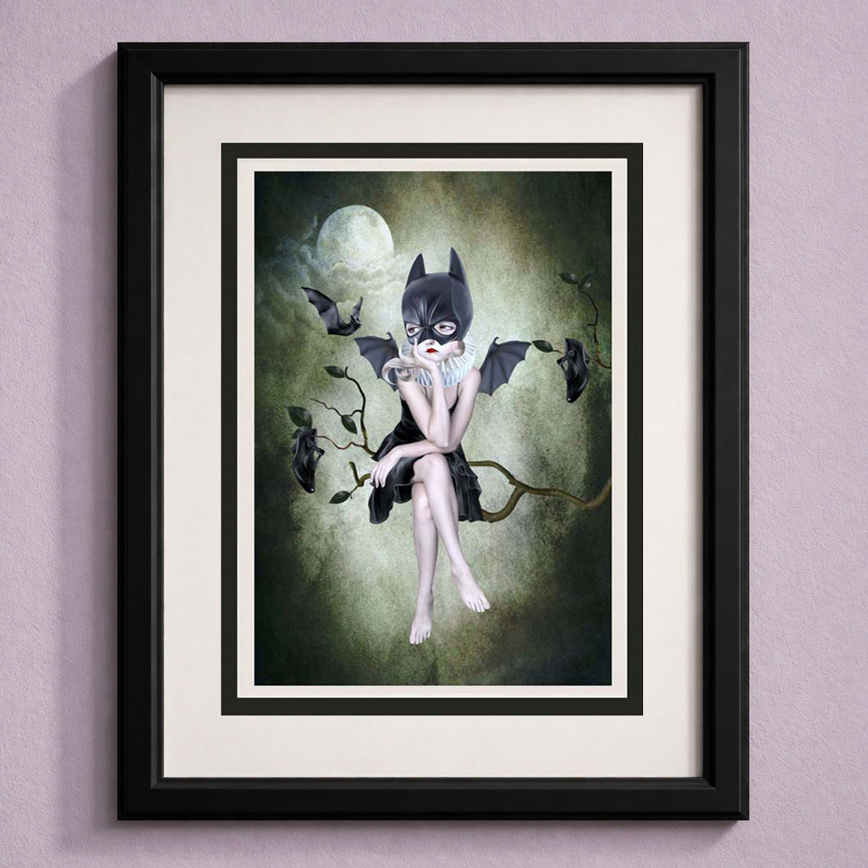 Framed art greeting card of a girl in a bat mask sitting on a branch with bats around, against a moonlit sky.