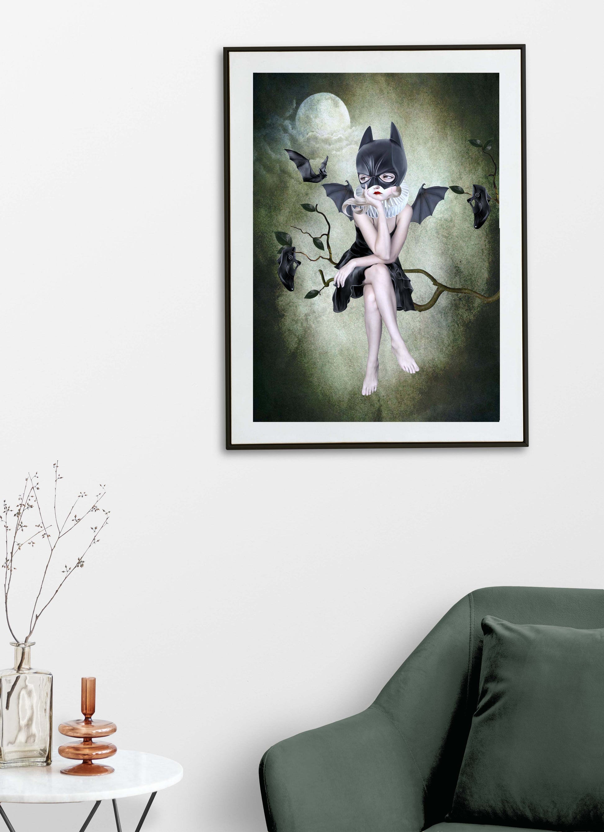 This whimsigoth print on a living room wall features a girl in a bat mask, perched on a branch under the moonlight, surrounded by flying bats.