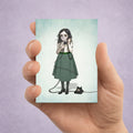 Big Eye Girl And Rotary Phone ACEO art card print in a hand to show miniature scale.