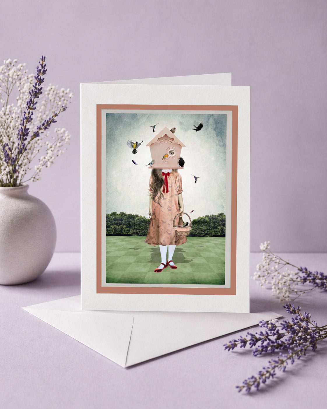 Greeting card with a quirky illustration of a of a girl with a birdhouse on her head, surrounded by birds, on a light purple background.