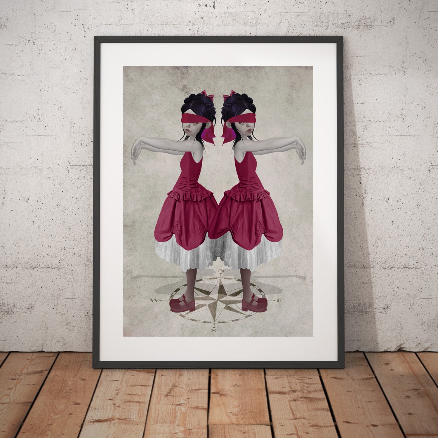 Surreal art print of blindfolded twin sisters, displayed in a large black frame, leaning against a white wall. This emotional surreal piece evokes depth and symbolism.