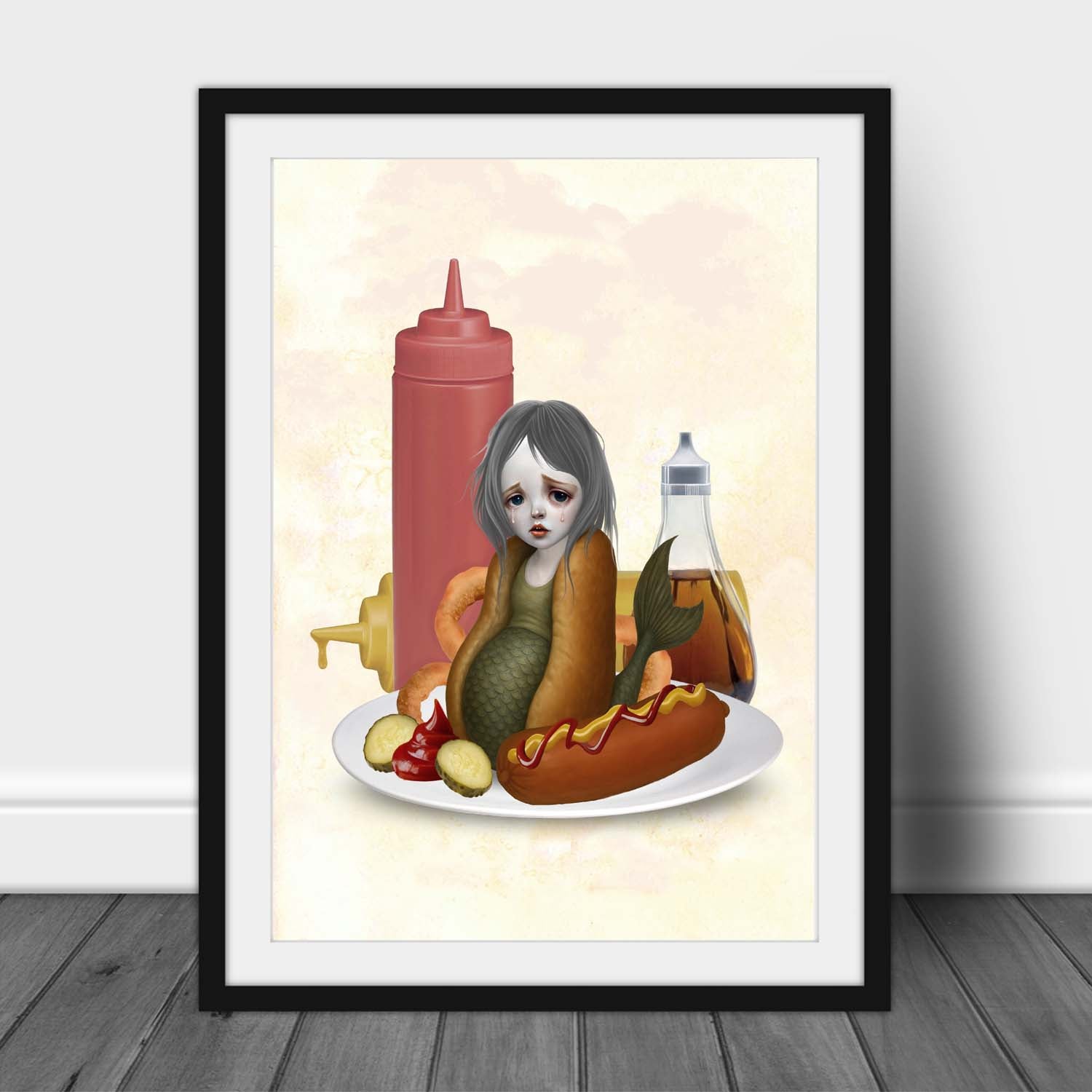 Framed artwork of a mermaid character on a plate between hot dog  bun and condiments, Quirky Kitchen decor.