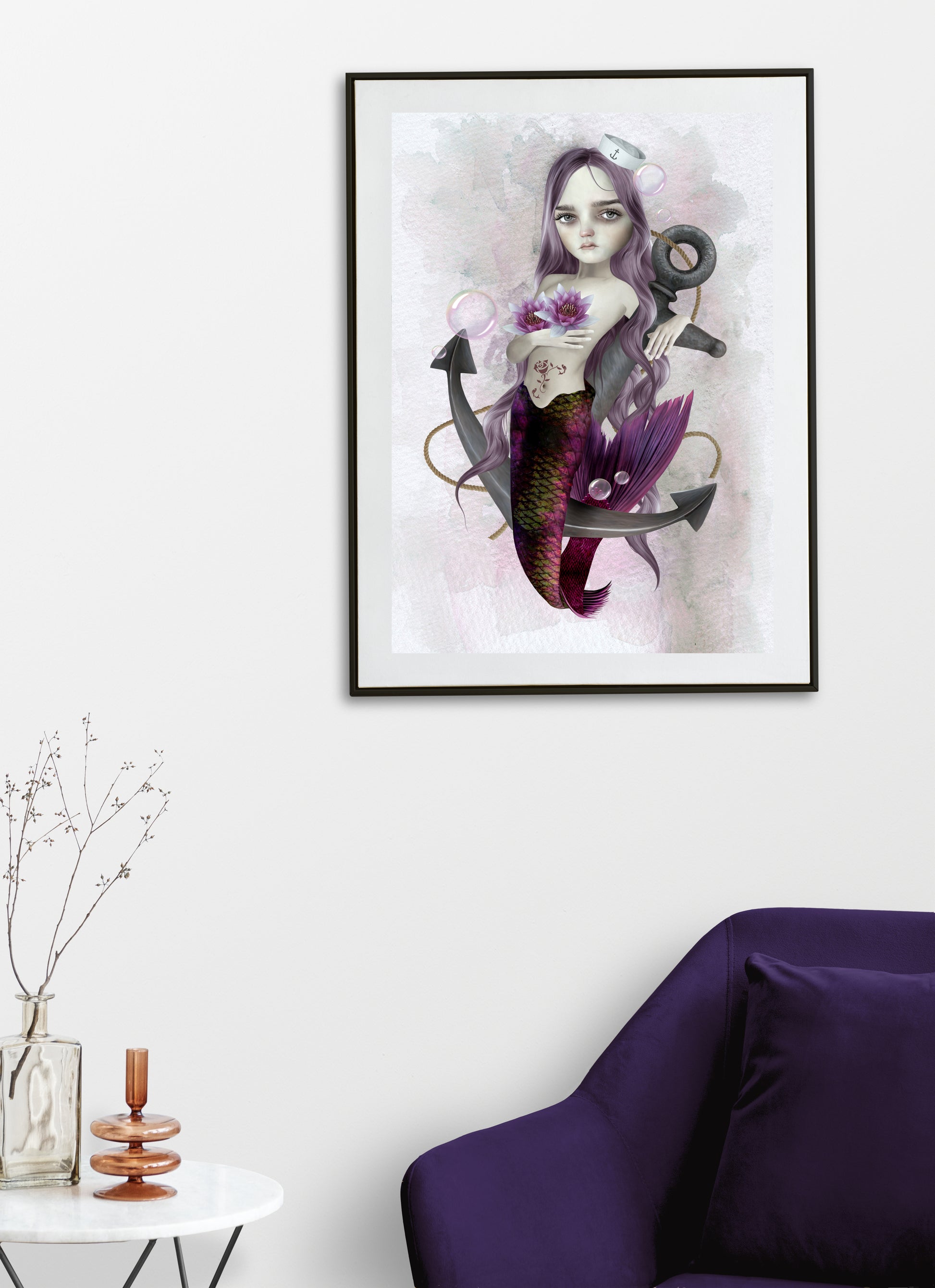 Mermaid and anchor art print hanging on the wall of a modern living room. Perfect for adding a nautical  touch to your home decor.