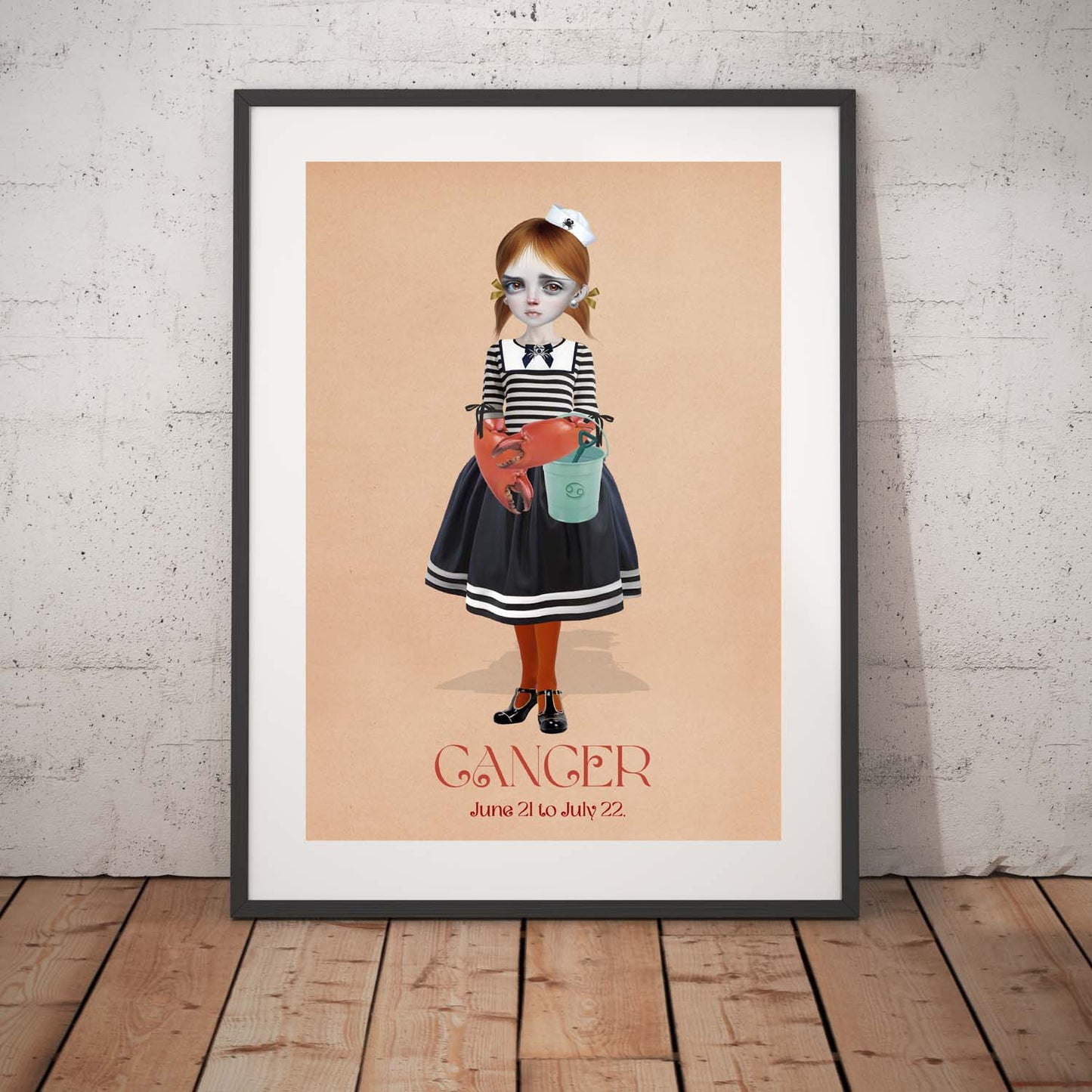 Cancer star sign art print in a black frame, standing against a white wall.