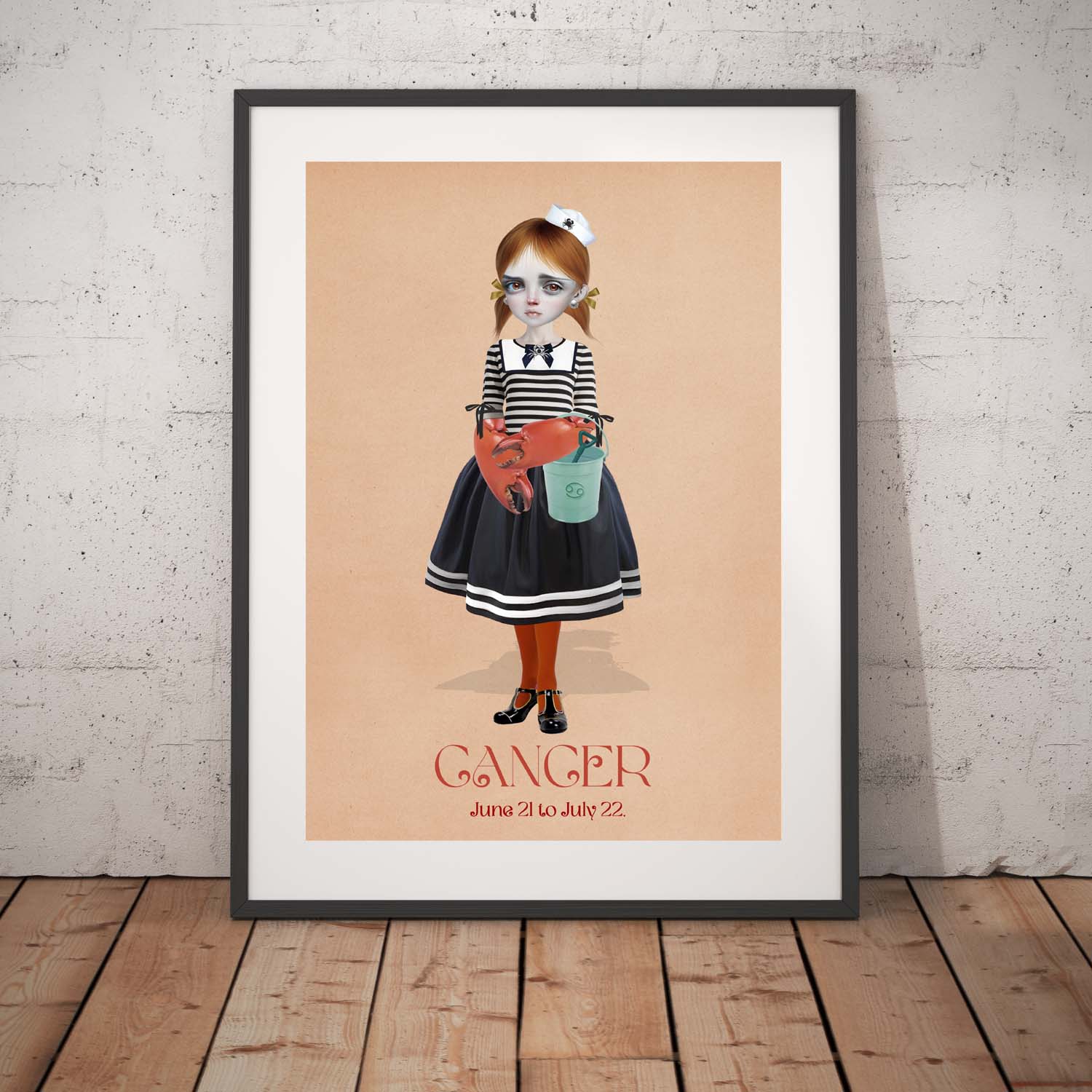 Cancer star sign art print in a black frame, standing against a white wall.