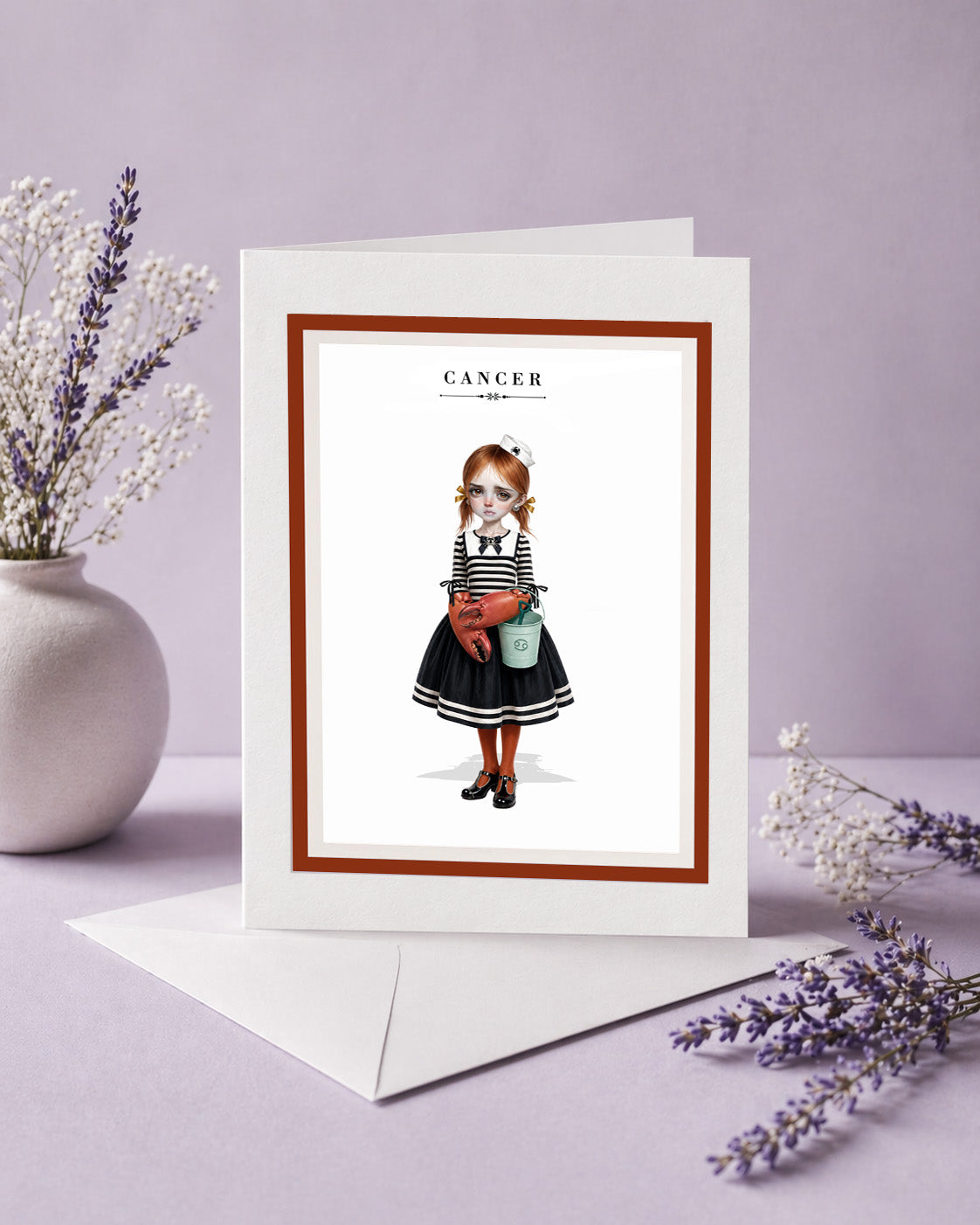 Cancer zodiac birthday card featuring an illustration of a red-haired maiden in a nautical sailor dress with crab claw hands and a beach bucket.