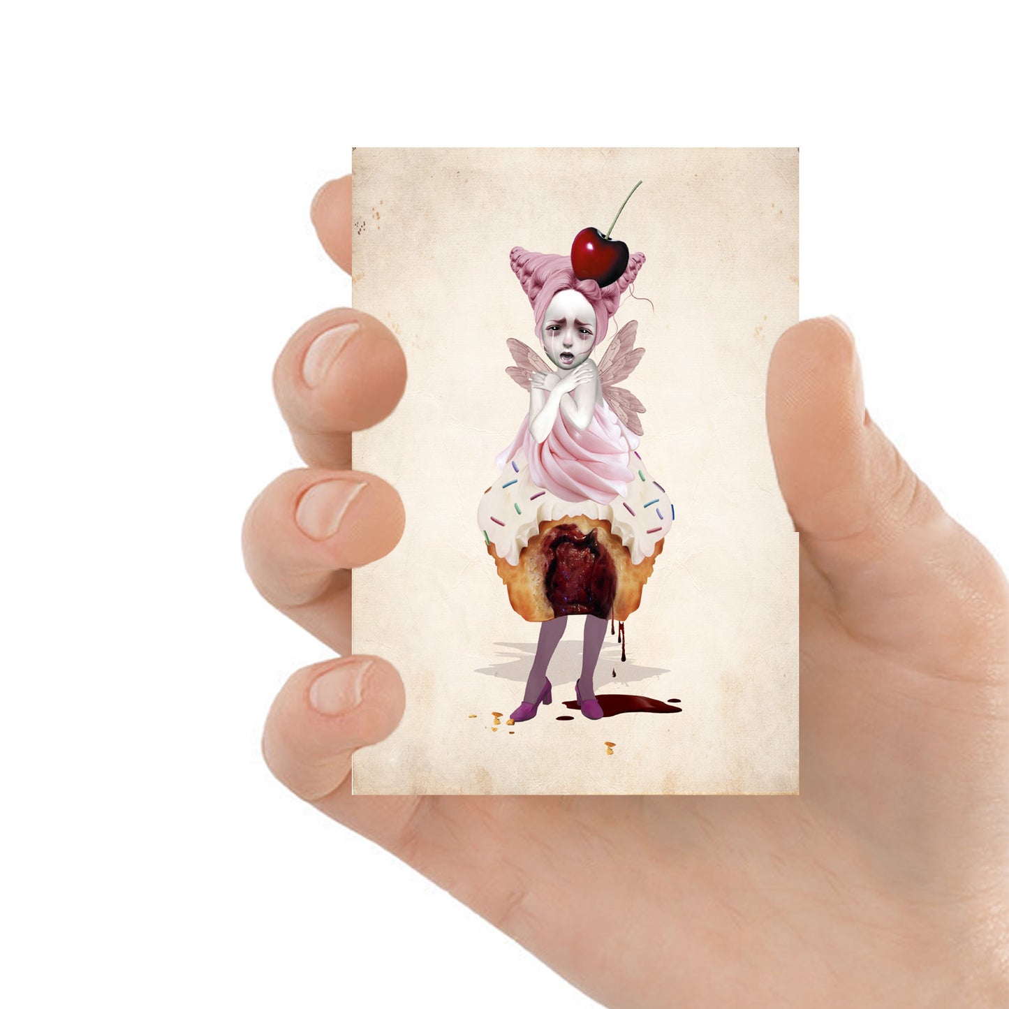 Creepy Cute Fairy Cake ACEO card held in a hand, showcasing whimsical, dark fairy and cake-themed artwork on miniature card.