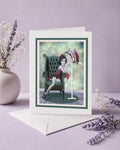 Art greeting card featuring a dark surrealism illustration of a girl, a vulture, and raw meat.