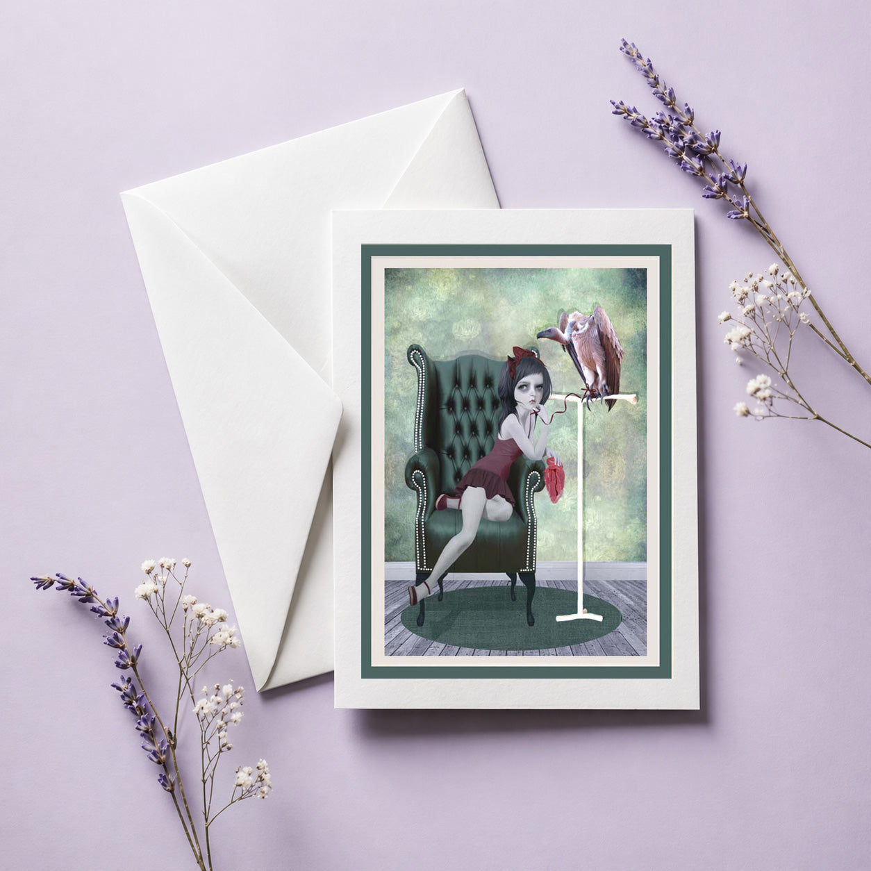 Blank macabre greeting card with envelope featuring a dark surrealism illustration of a girl, a vulture, and raw meat.
