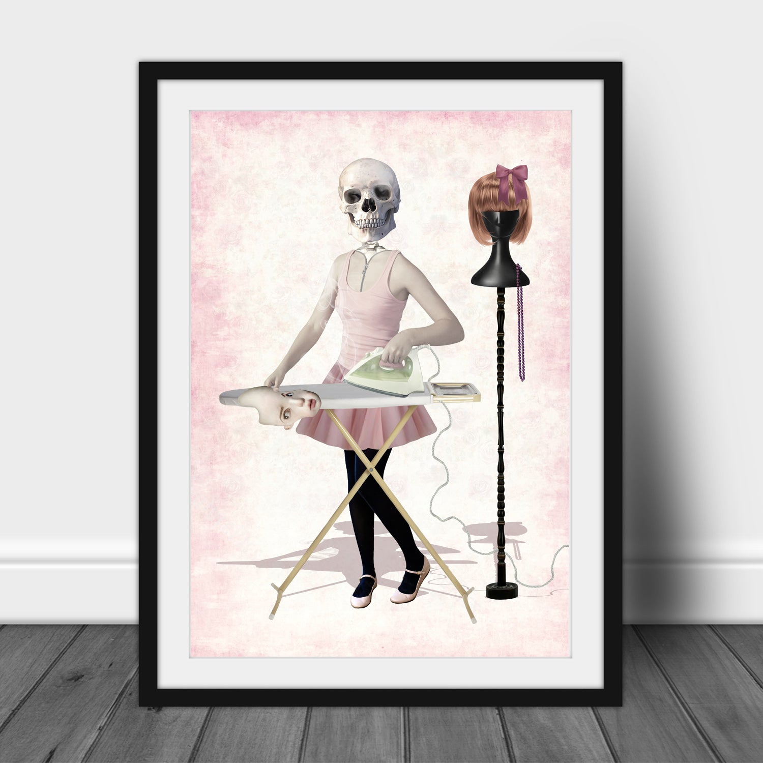 Framed artwork of a skeleton ironing a human skin suit on a pink background