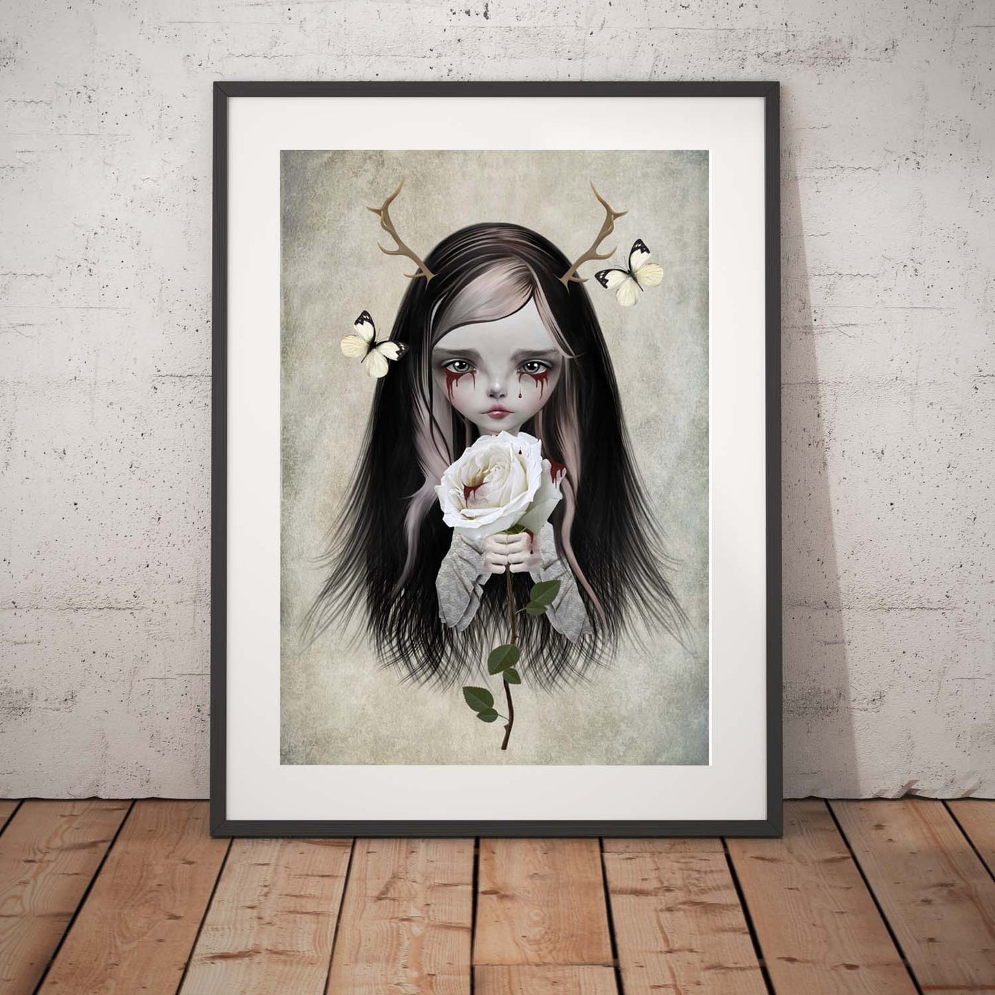 Creepy Cute Art Print. Featuring a hauntingly beautiful antlered girl with blood dripping from her eyes and clutching a white rose.