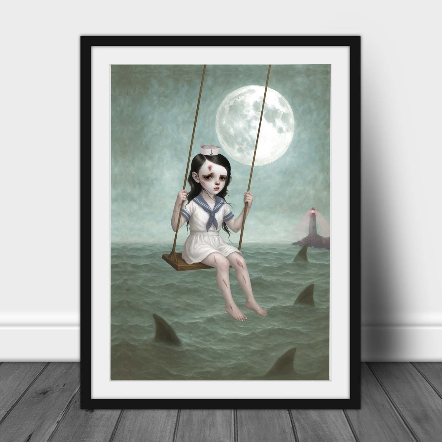 Gothic sailor girl art print in black frame leaning against wall with moonlit ocean and shark fins.