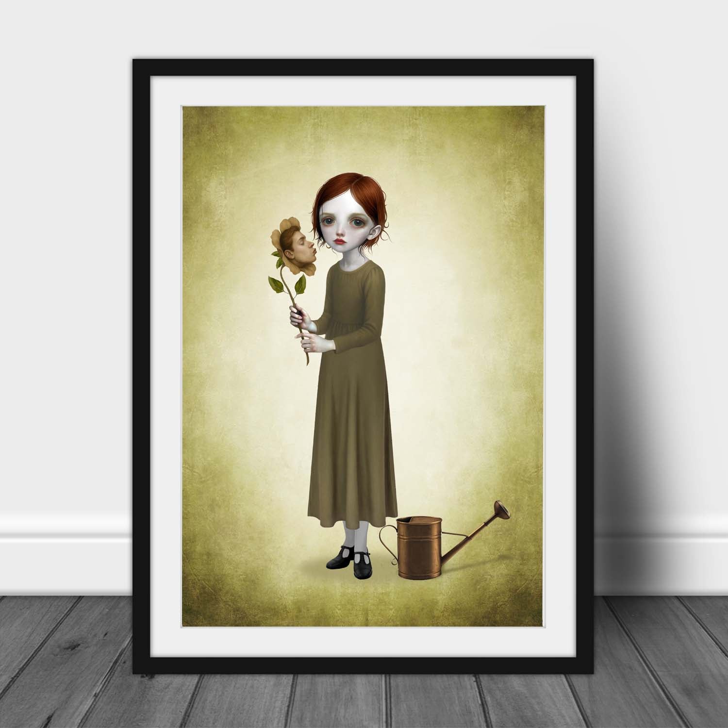 Surreal botanical print in a black frame leaning against a white wall, highlighting the dark romance aesthetic and muted green color palette.