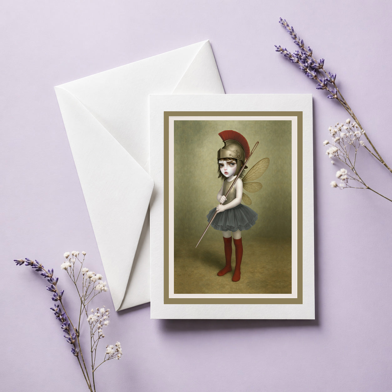 Surreal art greeting card & envelope. Featuring a fierce, big-eyed dark fairy dressed as an ancient warrior—complete with a plumed Roman helmet and a sewing needle spear.
