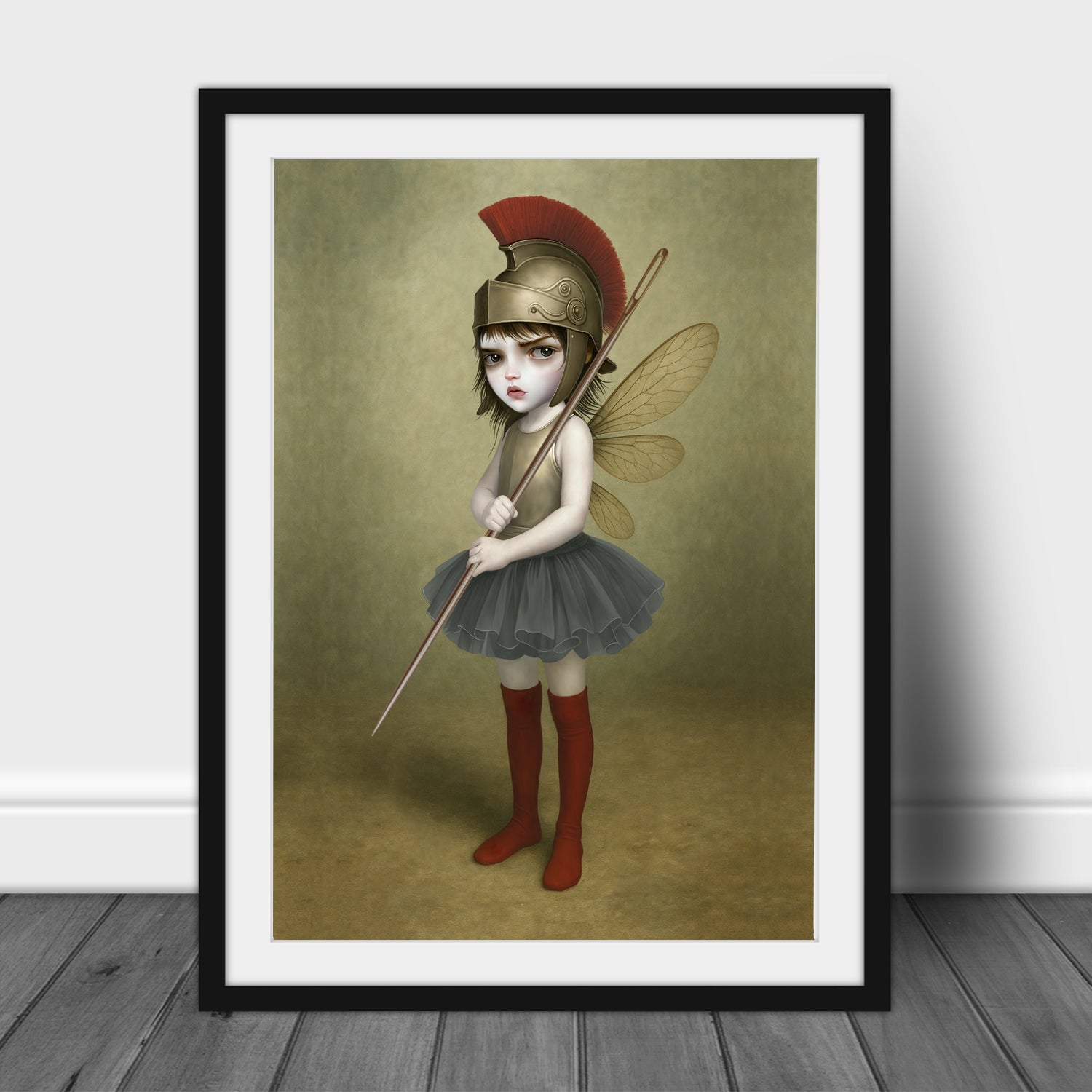 surreal fantasy art print in an A3 frame features a fierce, big-eyed dark fairy dressed as an ancient warrior. Donning a magnificent Roman-style plumed helmet and holding a sewing needle as a spear.