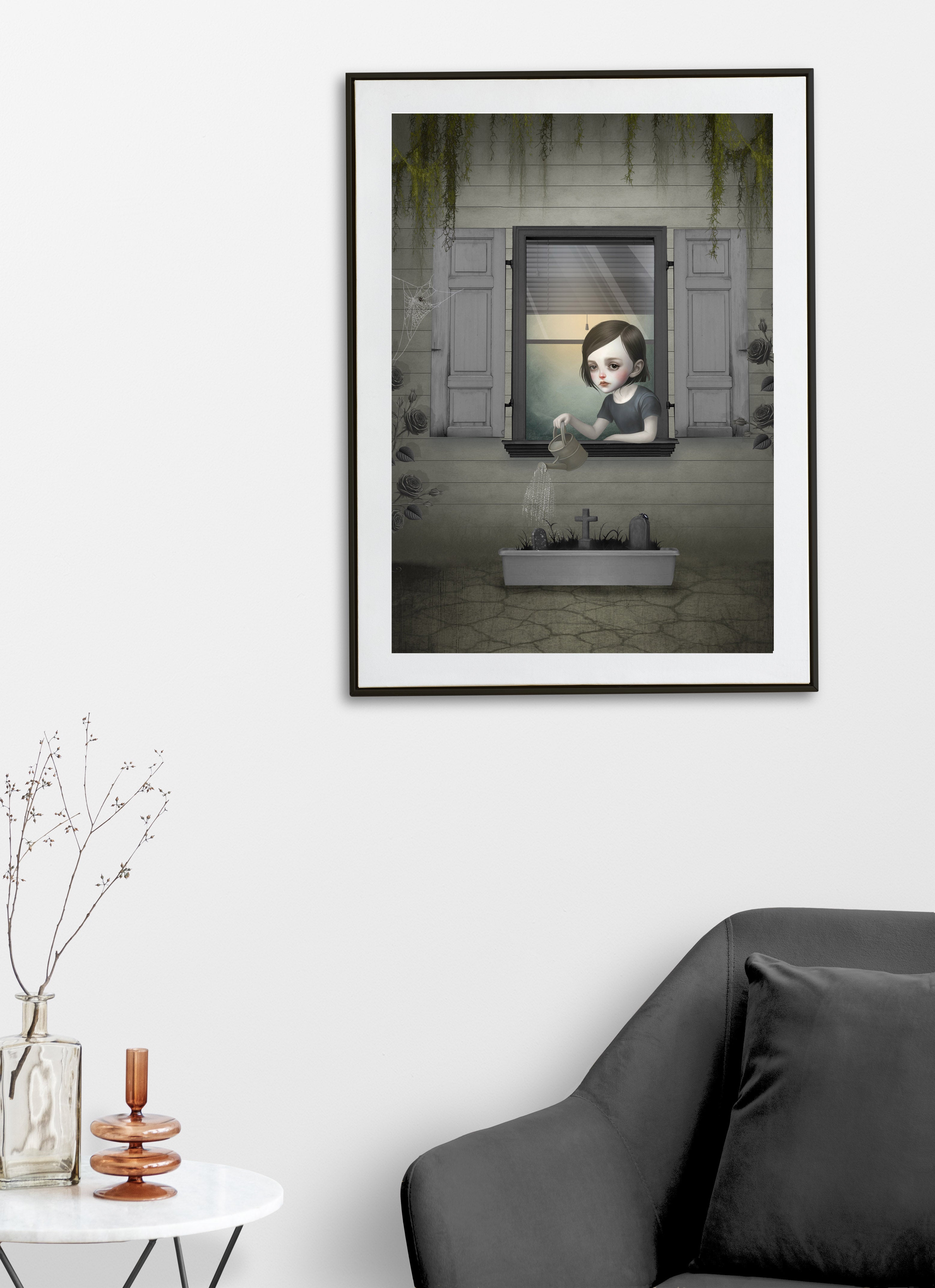 Dark surrealism girl window art print on a living room wall featuring a gothic girl watering a miniature graveyard planter with roses.