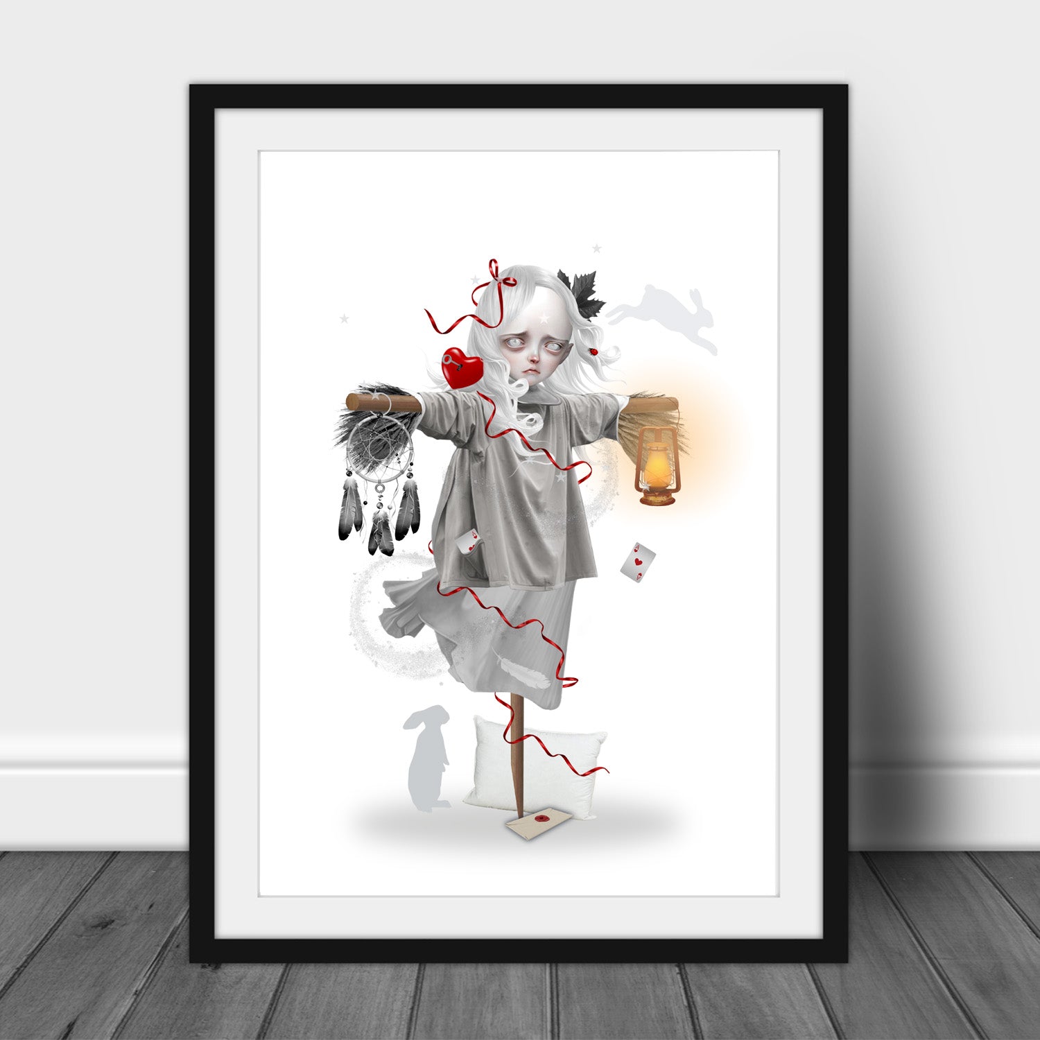 Art print of a dream scarecrow, in a frame, leaned against a wall.