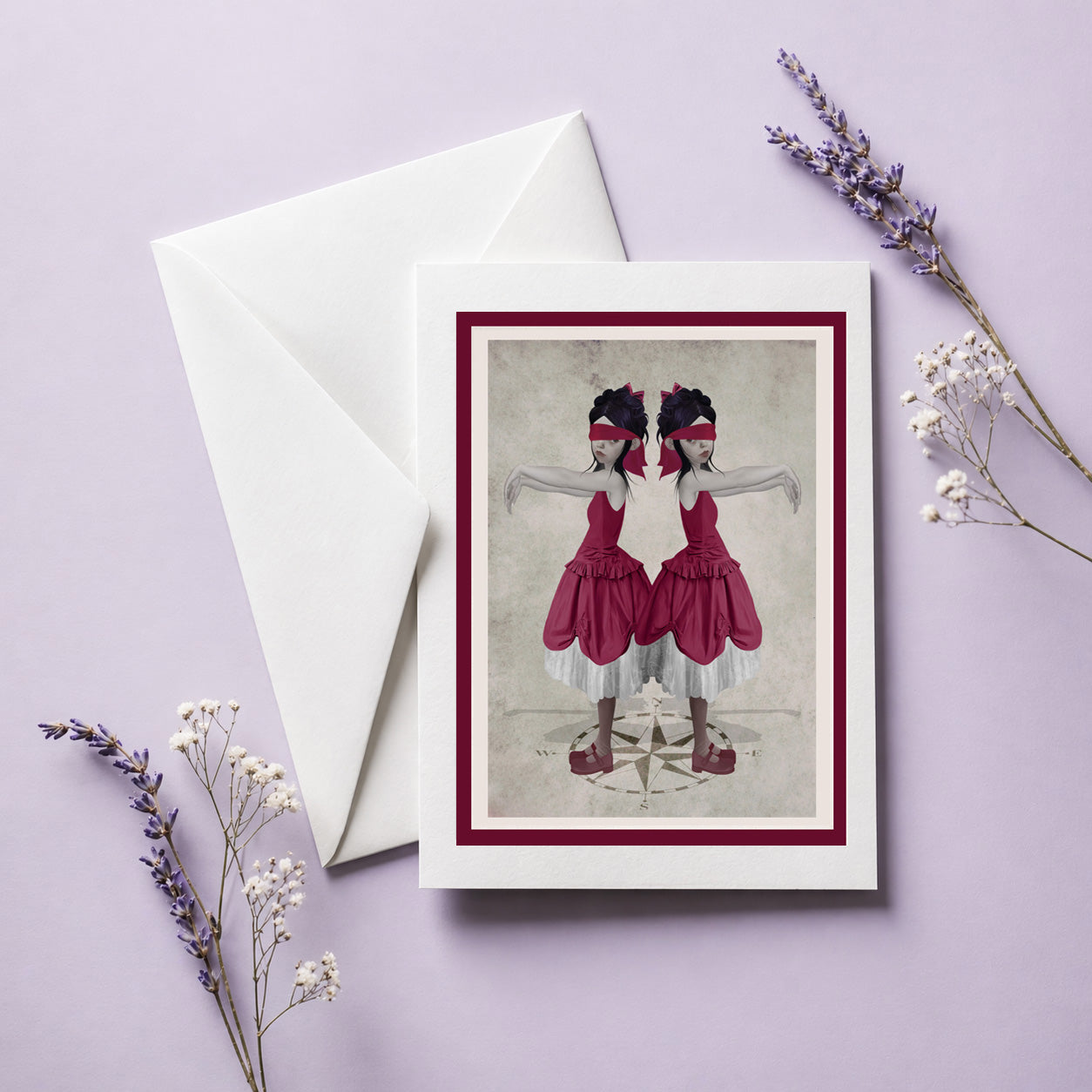 Art greeting card with a eerie illustration of twin sisters blindfolded standing on a compass, accompanied by a white envelope.