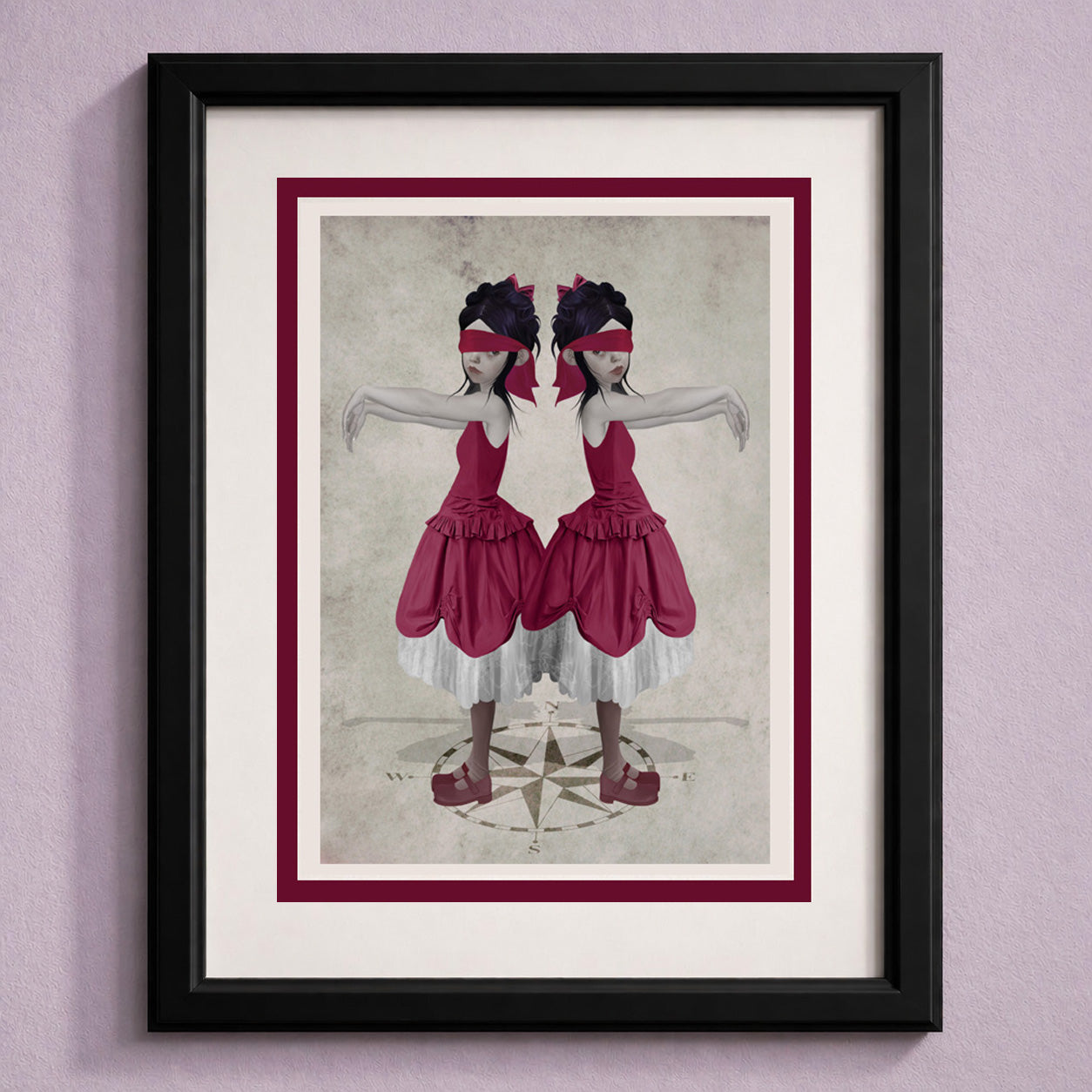 Framed art greeting card featuring twin sisters blindfolded stood above a compass.