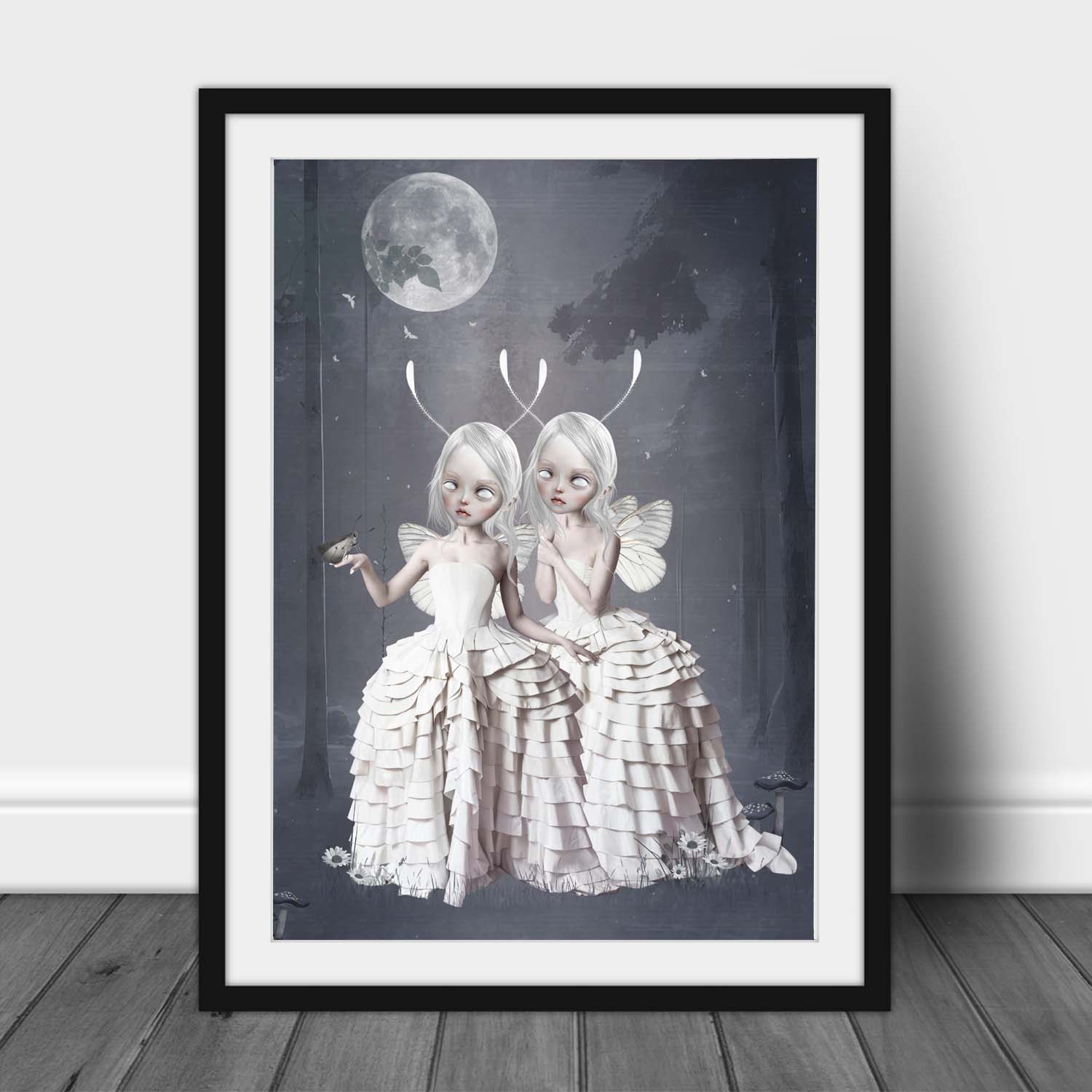 Framed Fantasy art print, image is  two Moth girls in an enchanted forest, with a moth gently landing on one moth girl's hand.