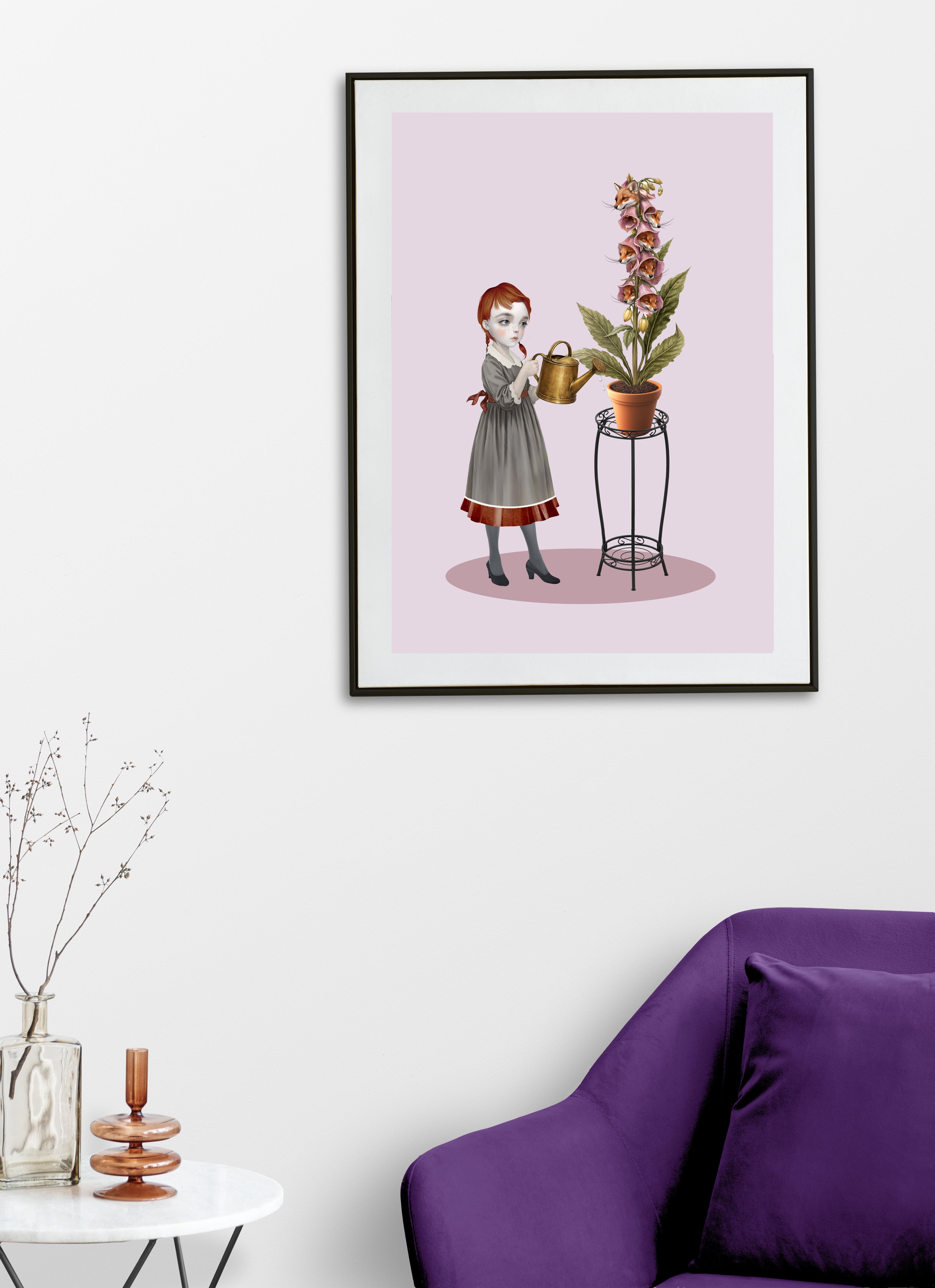 Framed artwork of a girl watering foxglove flowers on a pink background, displayed in a room with a purple sofa and decorative items.