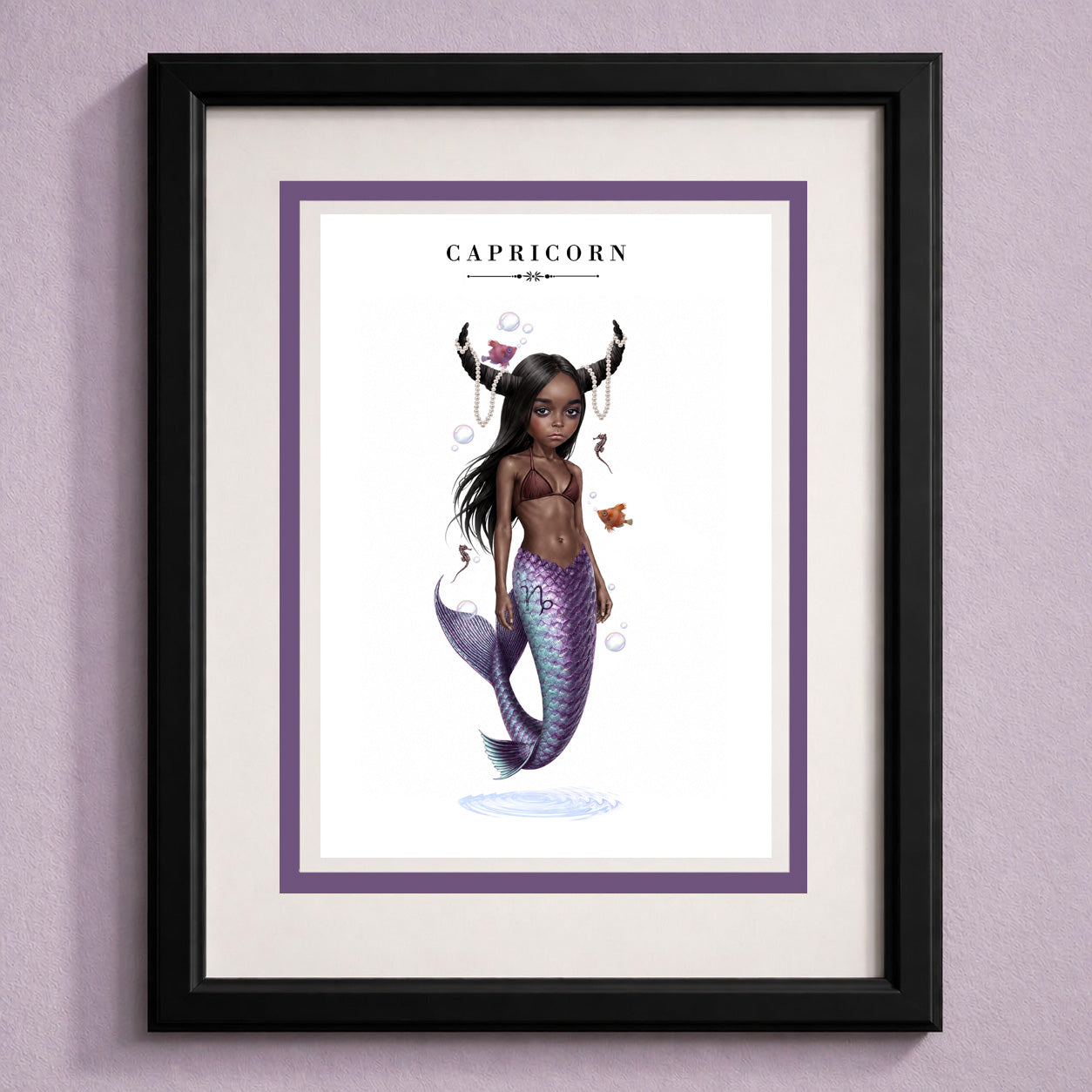 Framed Capricorn zodiac birthday card featuring an illustration of a mermaid with dark skin, goat horns draped in pearls, and a iridescent purple fish tail.