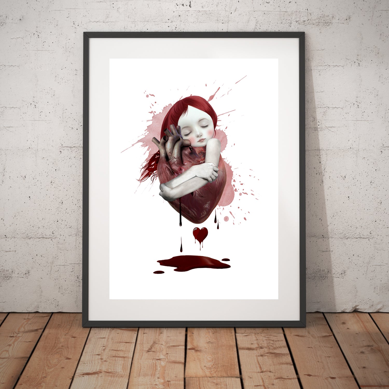 Contemporary Art Print in frame features a young girl hugging an oversized, bloody anatomical heart.
