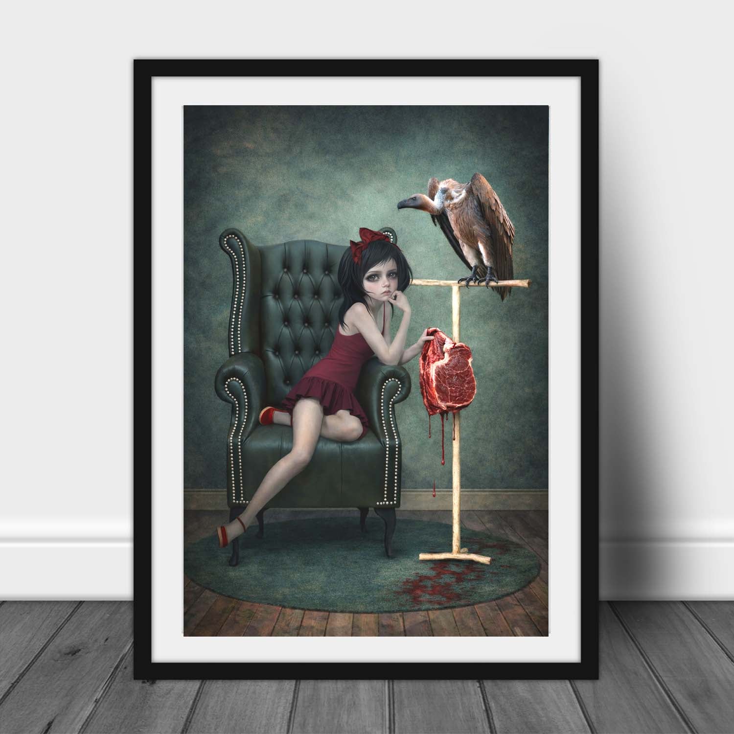 Framed artwork of a girl in a red dress offering her pet vulture raw meat