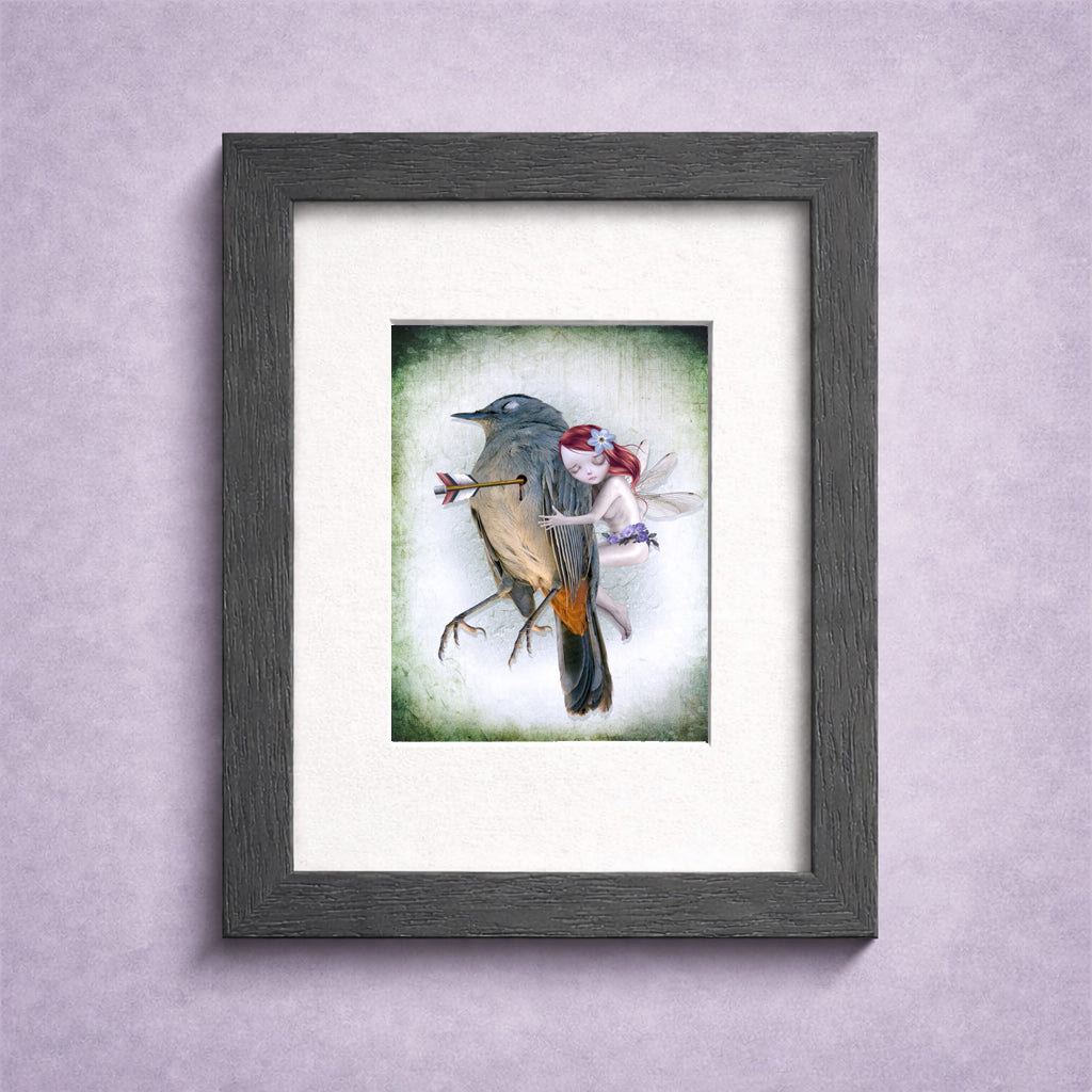 Framed artwork of dark fantasy ACEO art features a whimsical fairy comforting a wounded songbird.