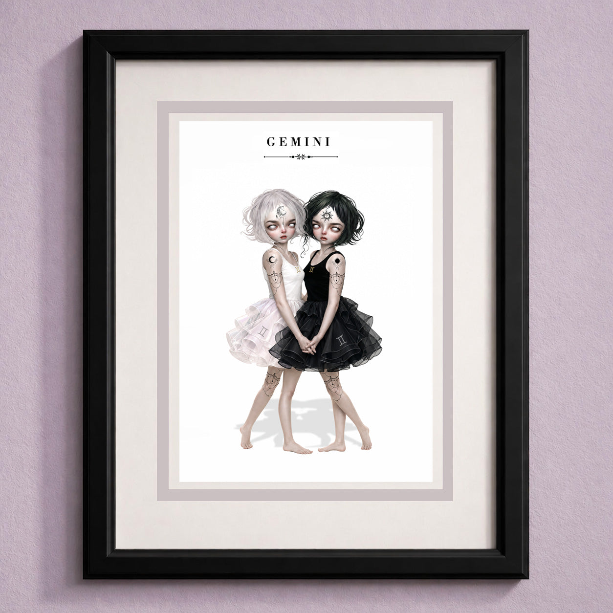 Framed Gemini zodiac birthday card featuring an illustration of twin maidens holding hands—one with white hair in a light dress and one with black hair in a dark dress.