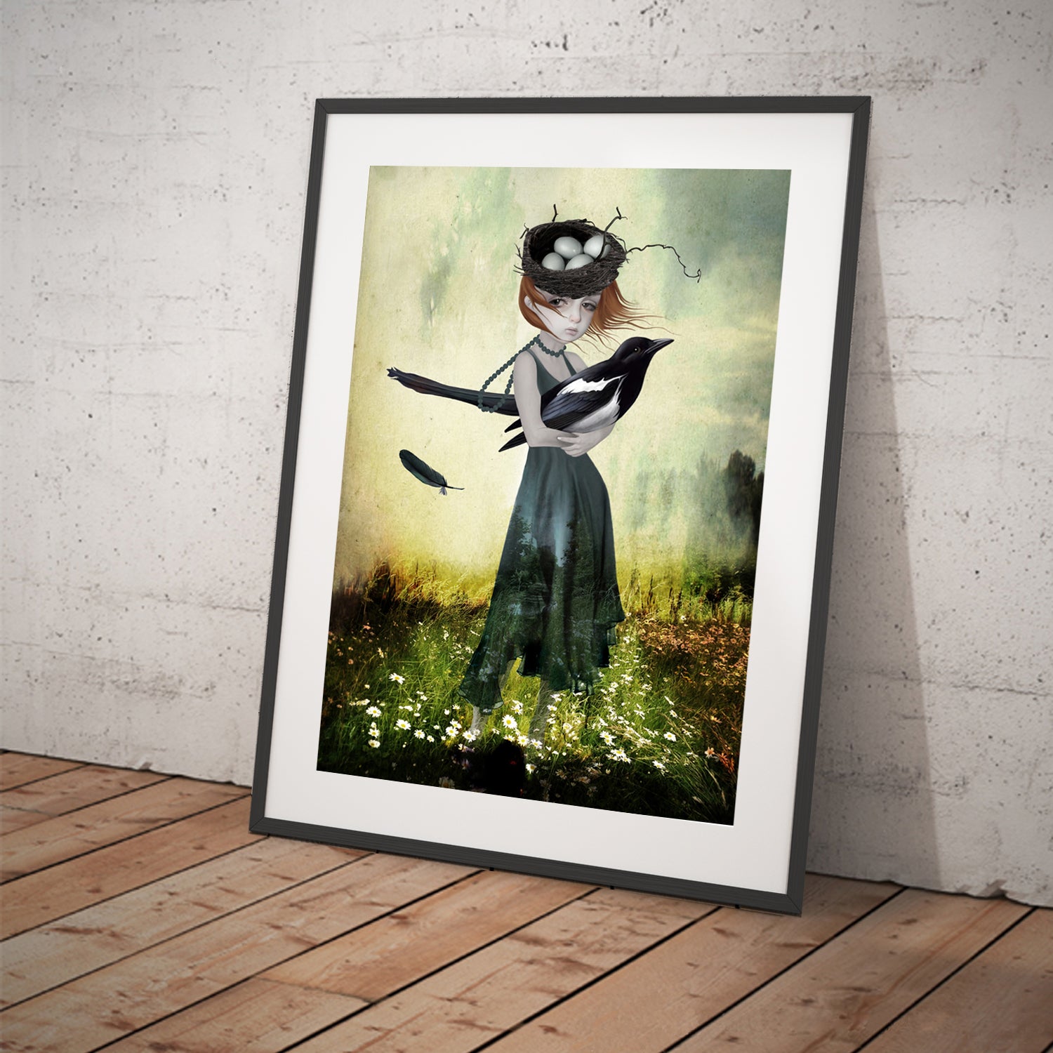 A girl holding an oversized magpie in a field of flowers in a black frame.