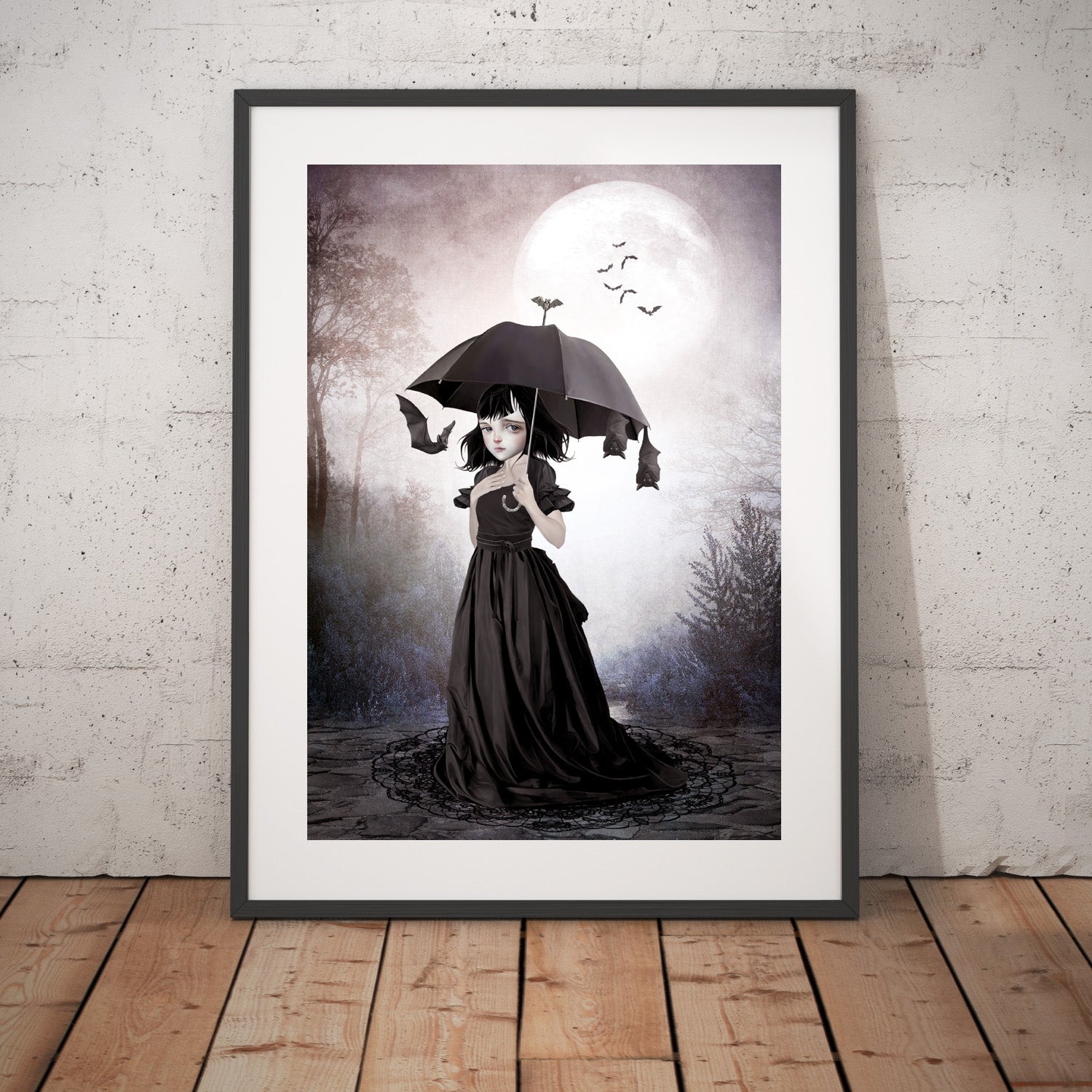 Framed gothic art print, image is a goth girl beneath the moonlight umbrella in hand, bats take slumber hanging from her umbrella.