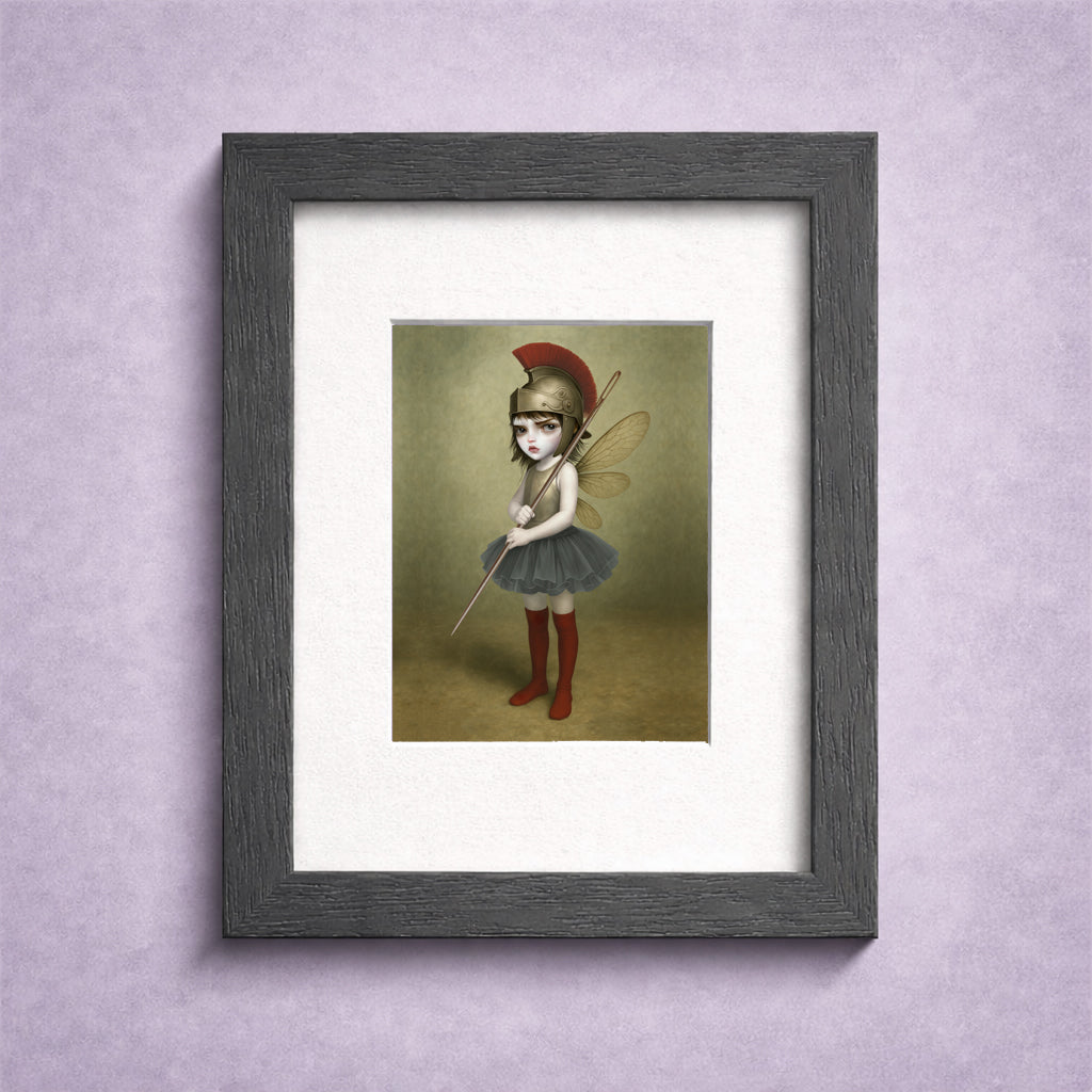 Framed surreal fantasy ACEO miniature art card print. Featuring a fierce, big-eyed dark fairy dressed as an ancient warrior—complete with a plumed Roman helmet and a sewing needle spear.