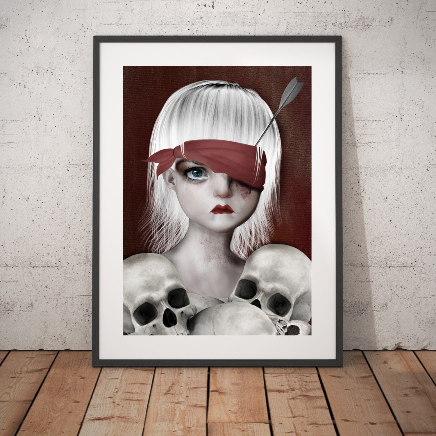 Memento mori wall art Print. Featuring a girl with an arrow in her eye surrounded by human skulls.