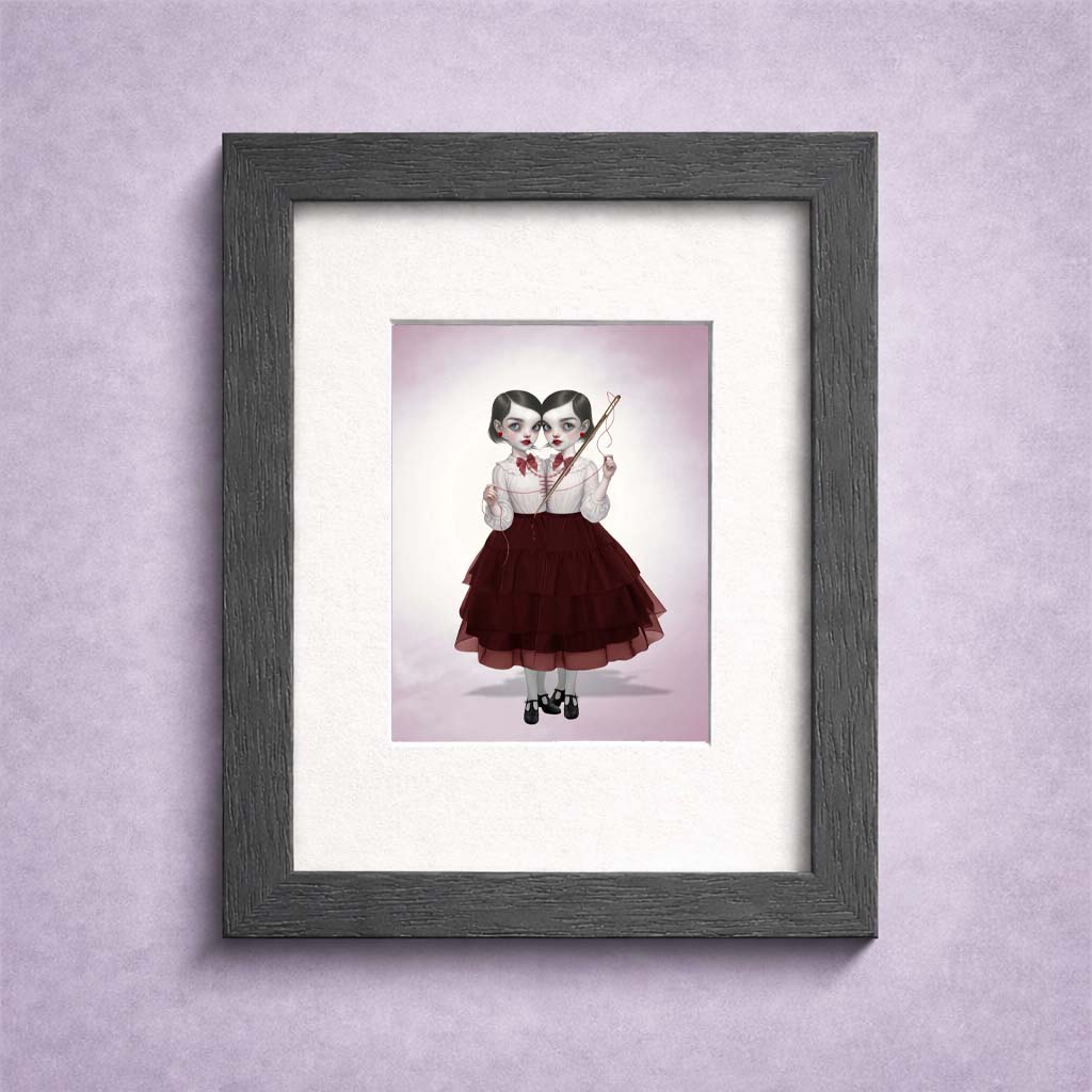 Collectible creepy cute ACEO art print in a small frame featuring a miniature dark surrealism illustration of conjoined twins sewing