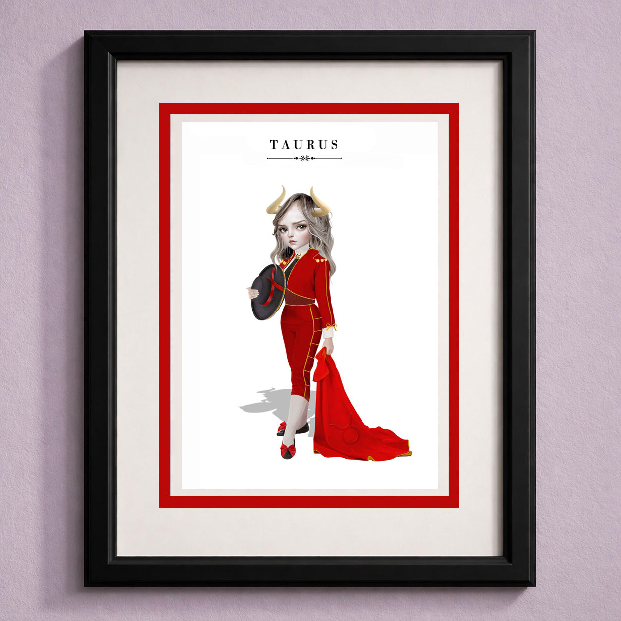 Framed Taurus zodiac birthday card featuring an illustration of a horned maiden in a red matador suit holding a red cape and hat.