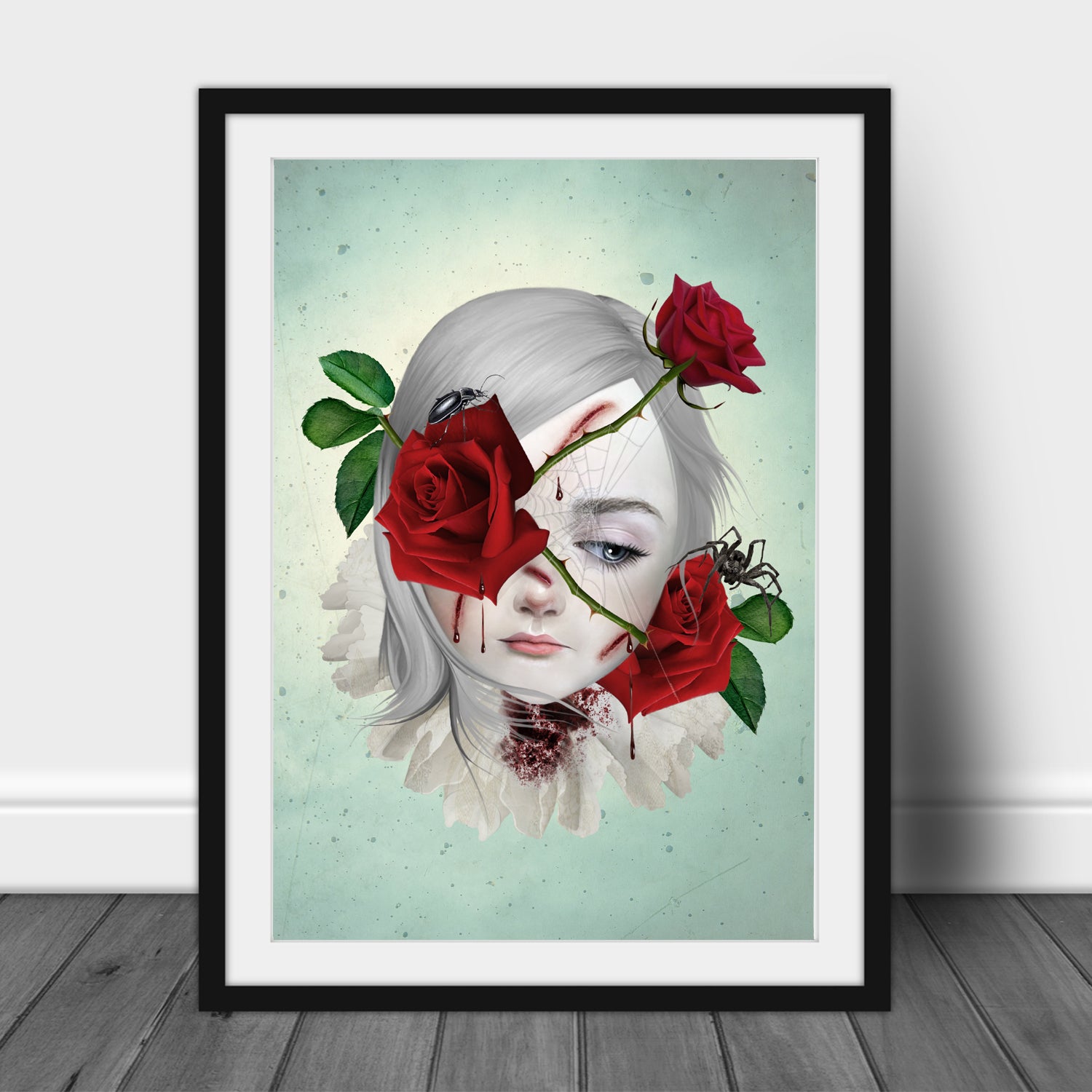 Framed art print of a girl with thorny red roses bleeding from the thorns, surrounded by a spider and beetle, displayed in a black frame. This surreal dark fantasy piece evokes emotion and symbolism.