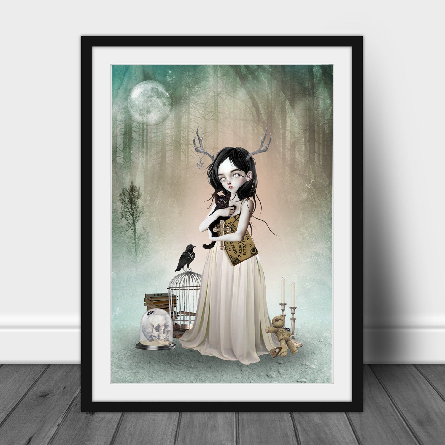 Framed Woodland Oracle Art Print leaning on a white wall.