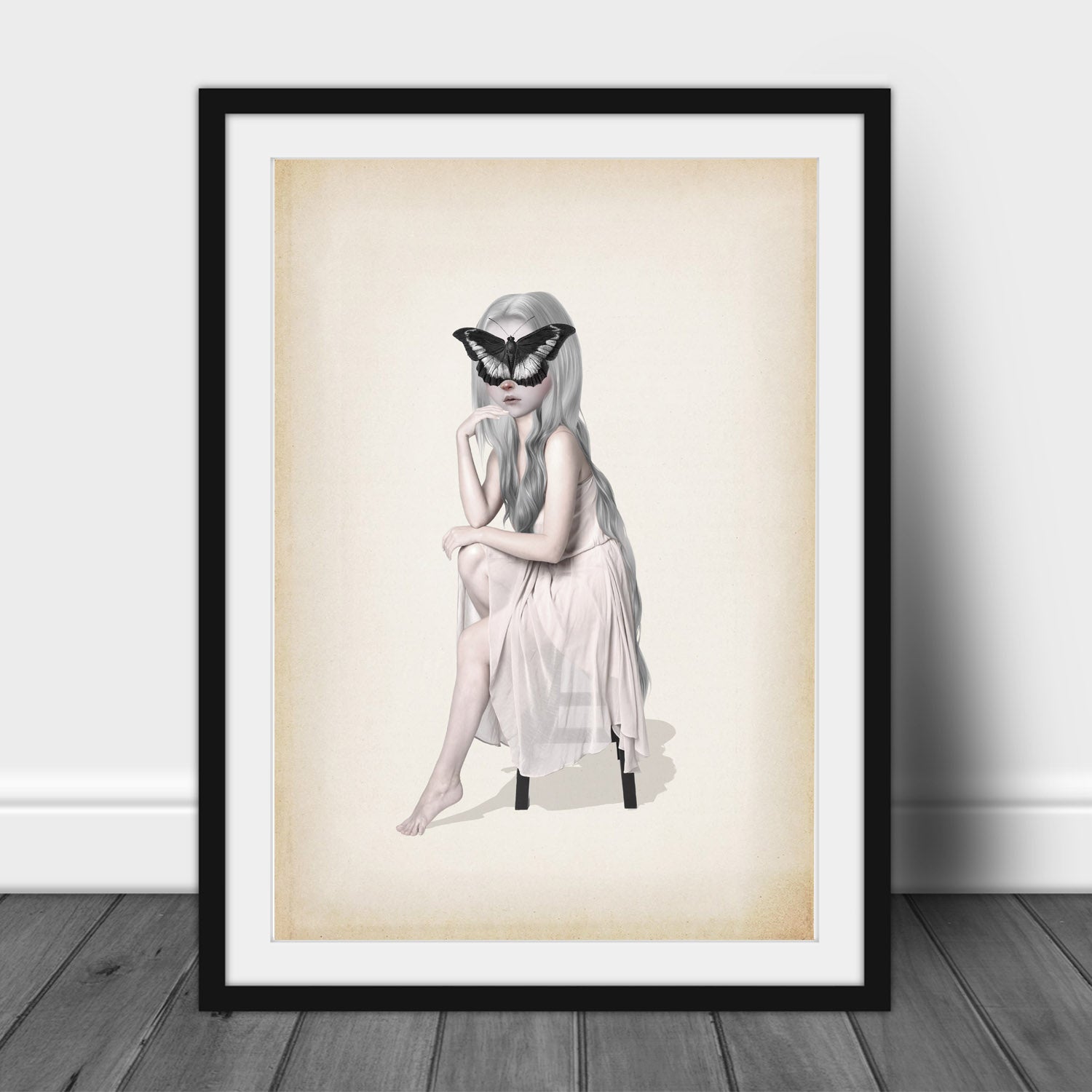 Butterfly Art Print depicts a dreamy girl in a flowing white dress, with a giant butterfly delicately resting on her face. 