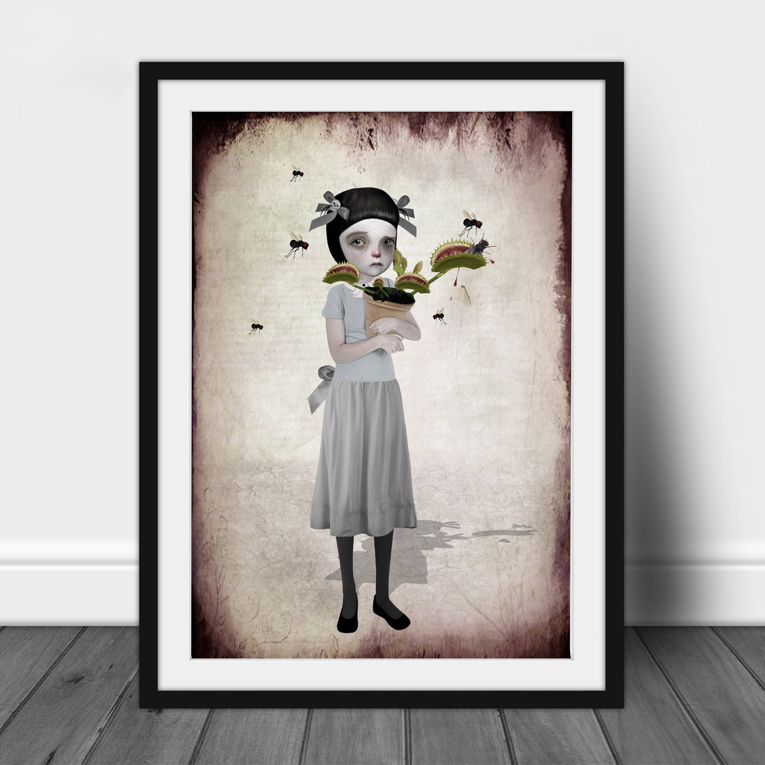 Framed carnivorous plant Art Print features a tearful girl holding her Venus Flytrap as it chomps on flies.